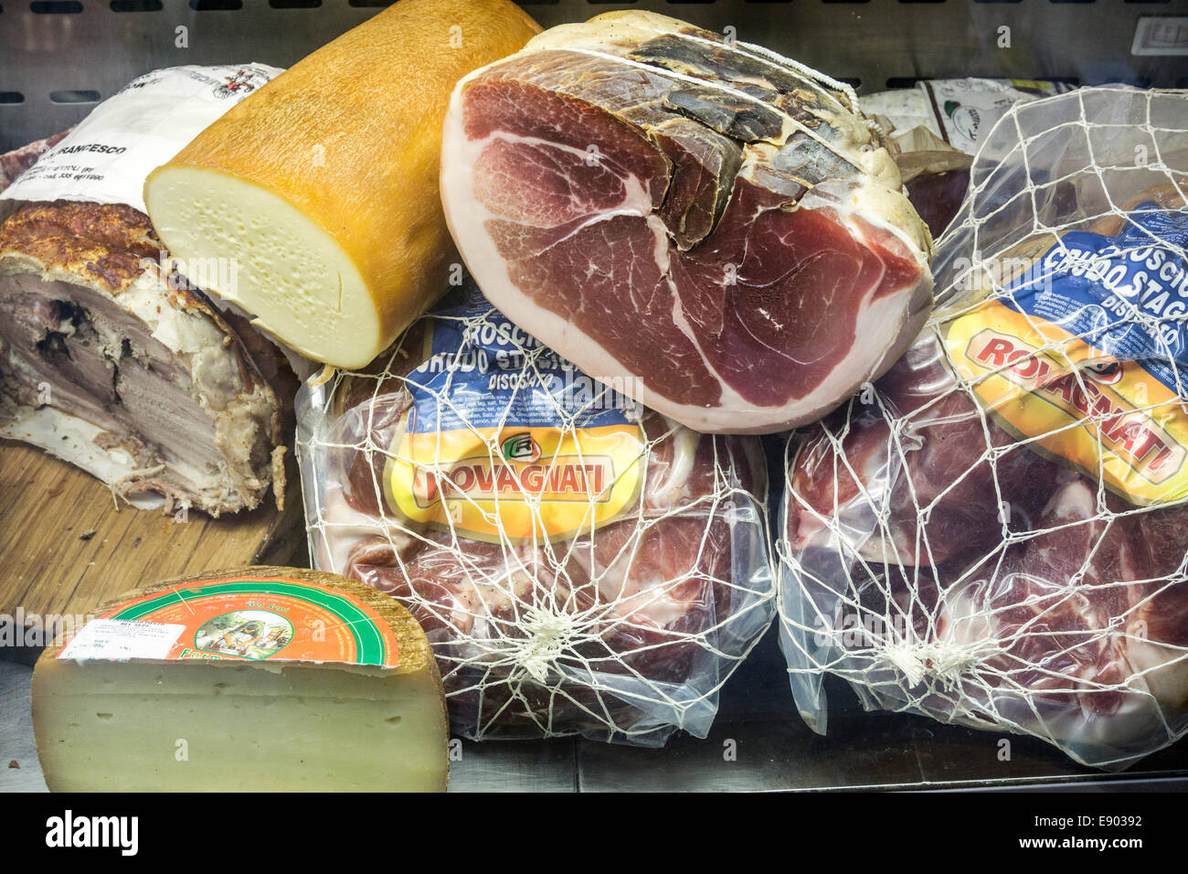 delicious tempting display of prosciutto cheeses & pork terrine in window of small shop selling Italian cold cuts prepared food Stock Photo