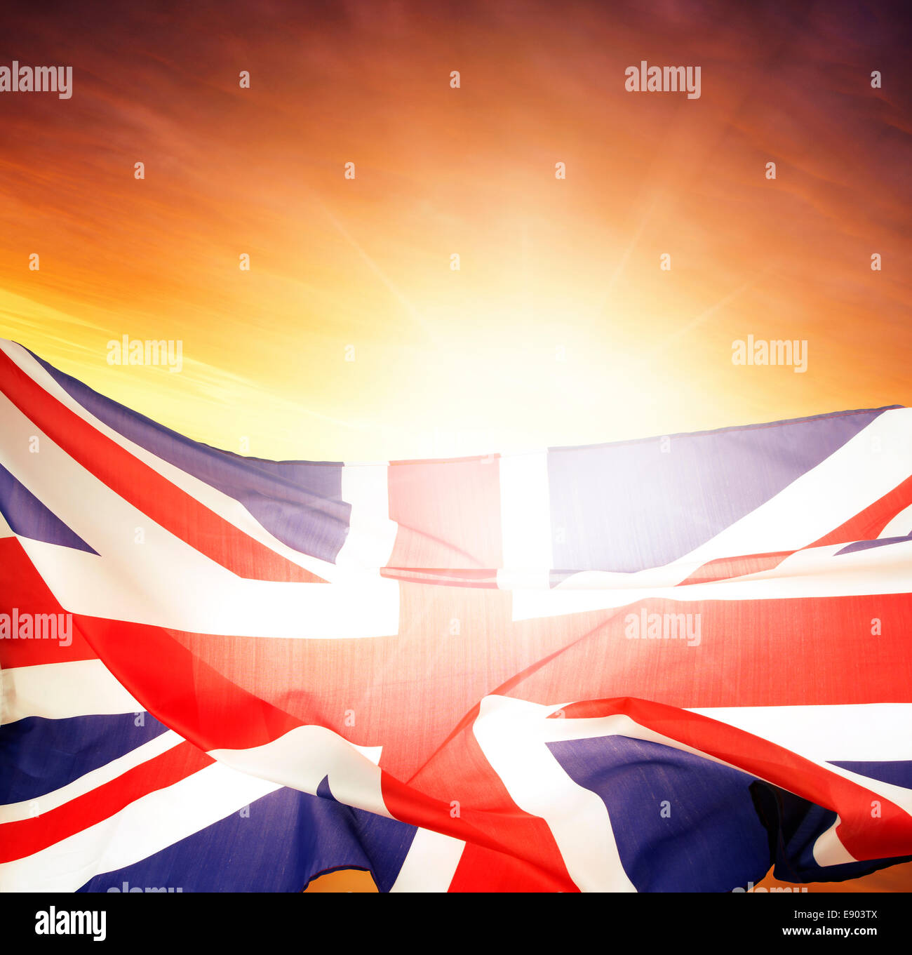 Union Jack flag in front of bright sky Stock Photo