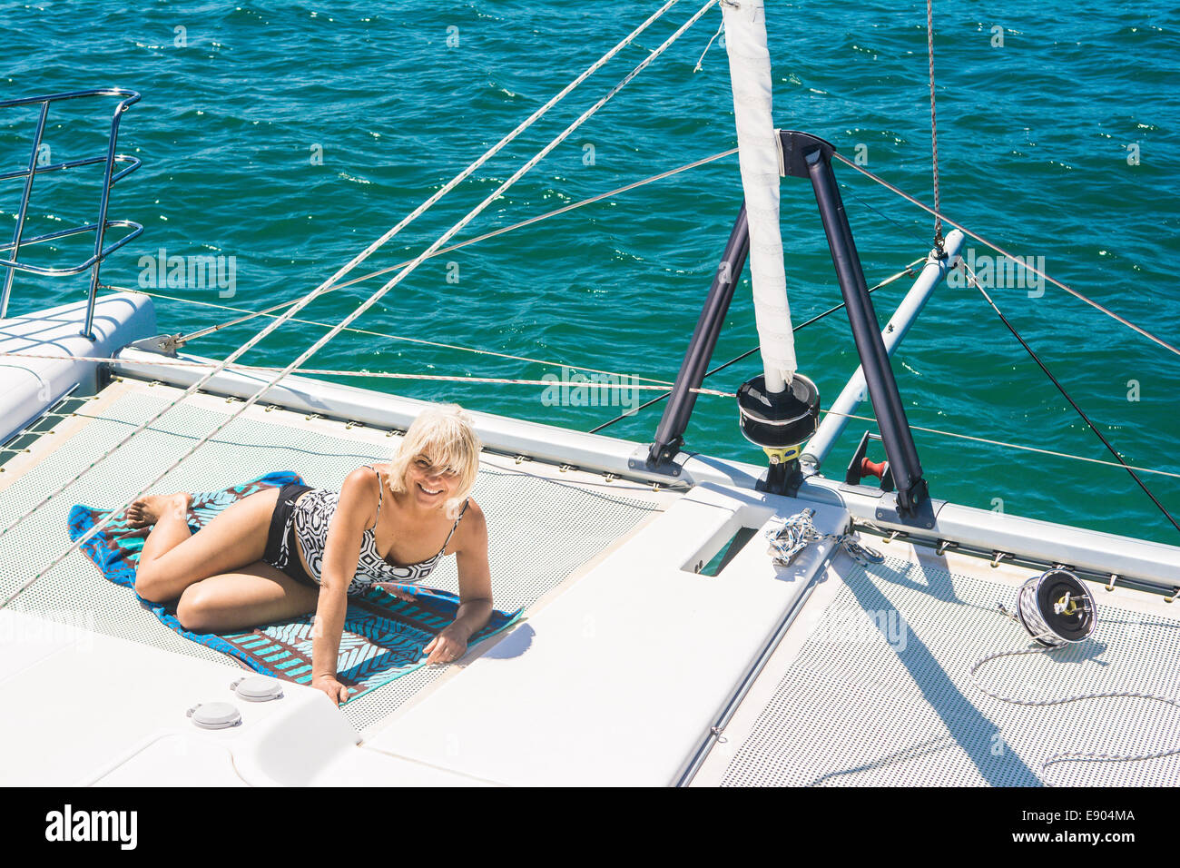 Woman onboard a catamaran sailing in Moreton Bay, Brisbane, Queensland, Australia Stock Photo