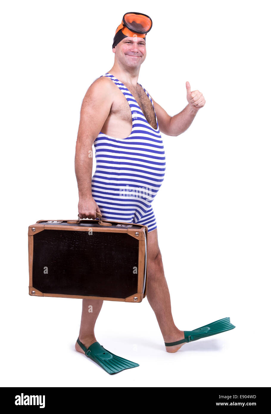 Man in swim dress walking with suitcase Stock Photo