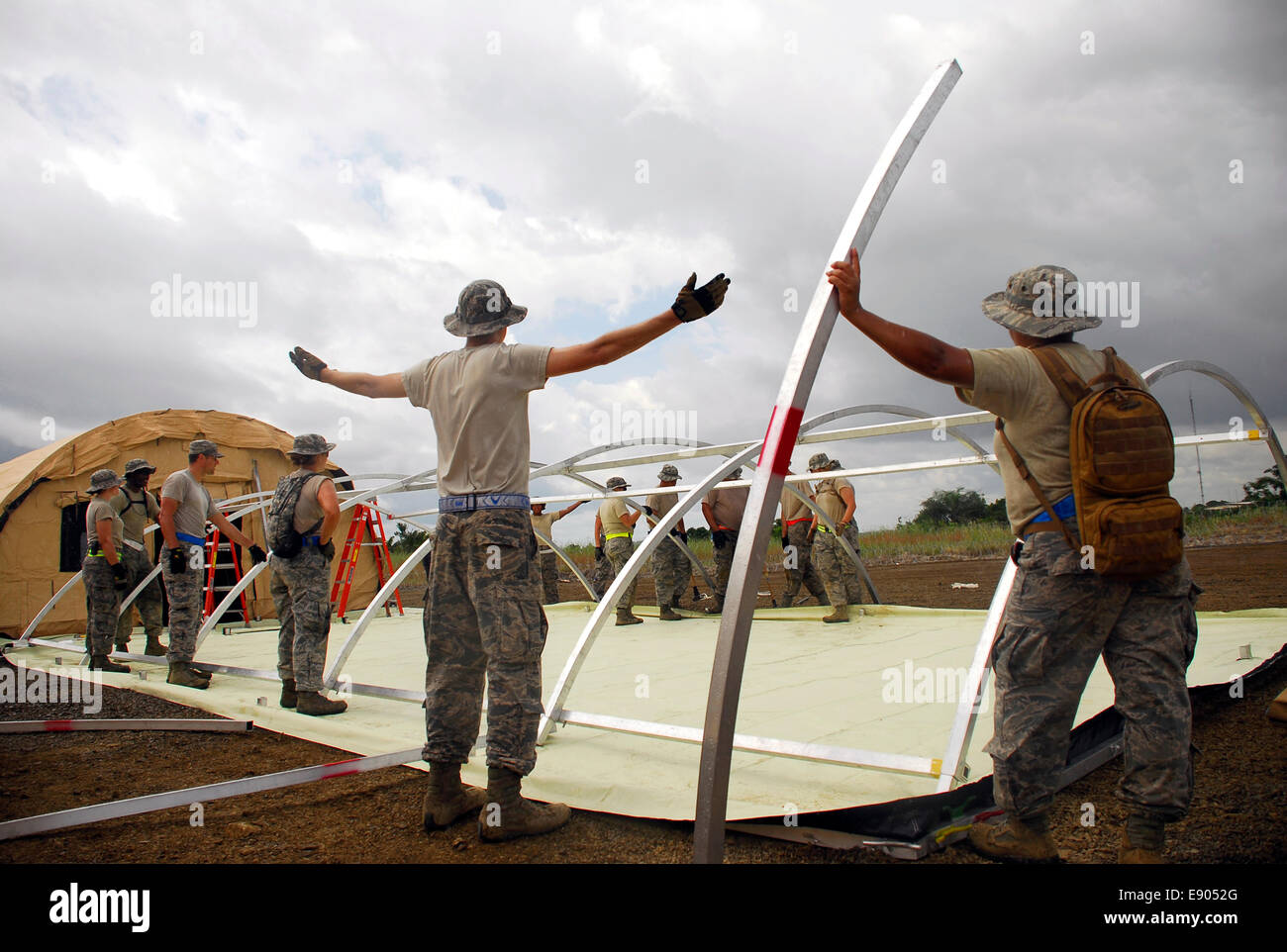 US Air Force airmen work to assemble a portable hospital October 9, 2014 in Monrovia, Liberia. The American troops will assist in the building of Ebola treatment units in the harder to reach areas of Liberia in an effort to contain the Ebola virus outbreak in West African nations. Stock Photo