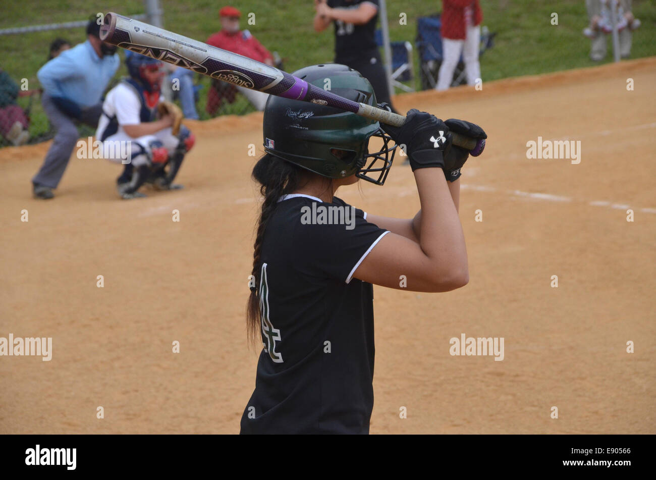 batter practicing her hitting  in a softball game Stock Photo