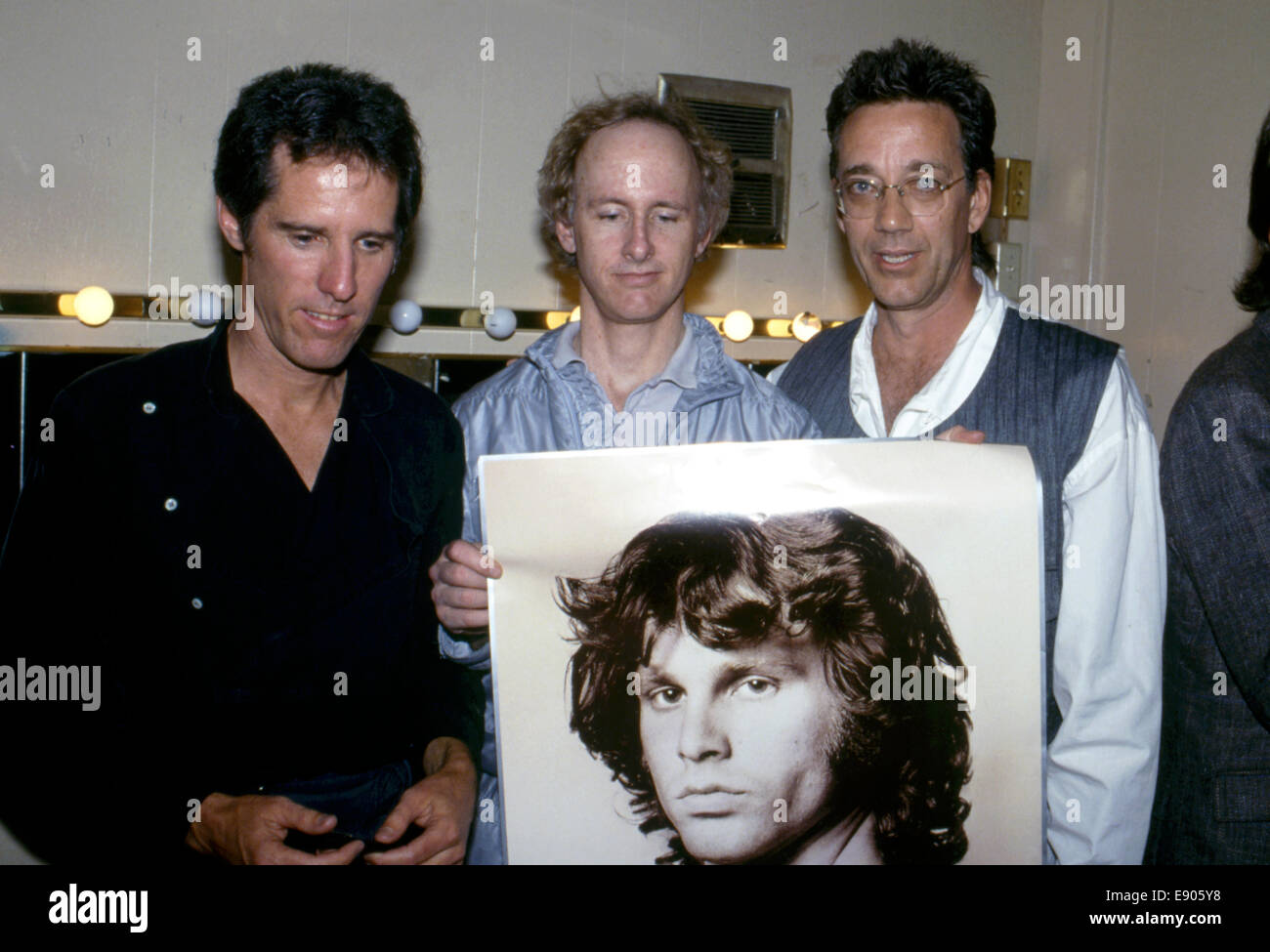 in 1984 the members of The Doors, John Densmore, Robby Krieger and Ray Manzarek hold a poster of Jim Morrison at release of L.A. Woman music video Stock Photo