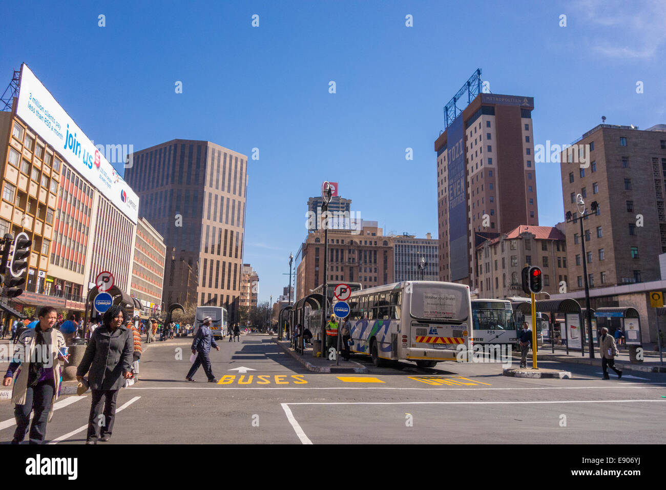 JOHANNESBURG, SOUTH AFRICA - Pedestrians and buses in city centre. Stock Photo