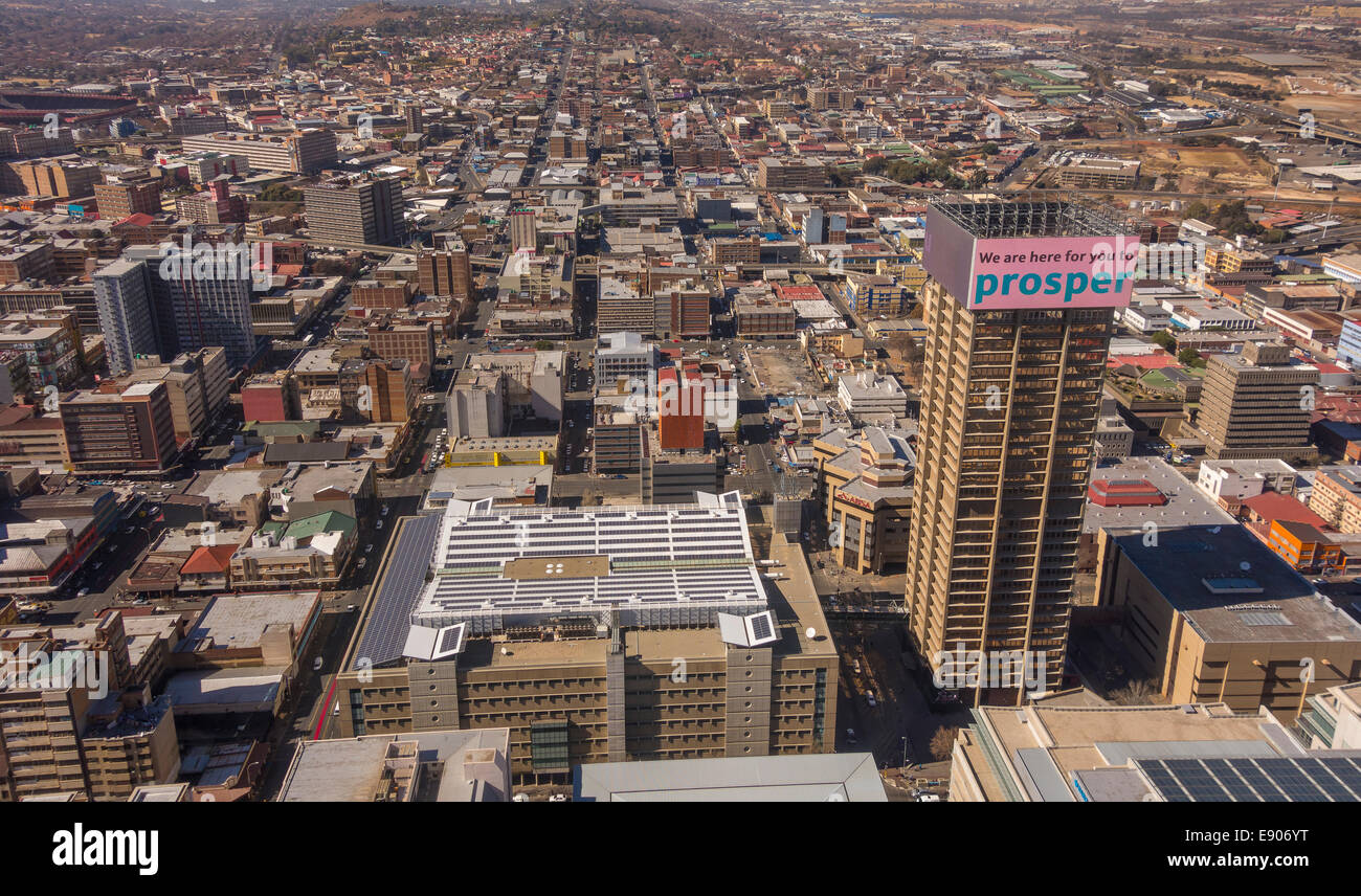 JOHANNESBURG, SOUTH AFRICA - Skyscraper in central business district, with billboard reading: We are here for you to prosper.' Stock Photo