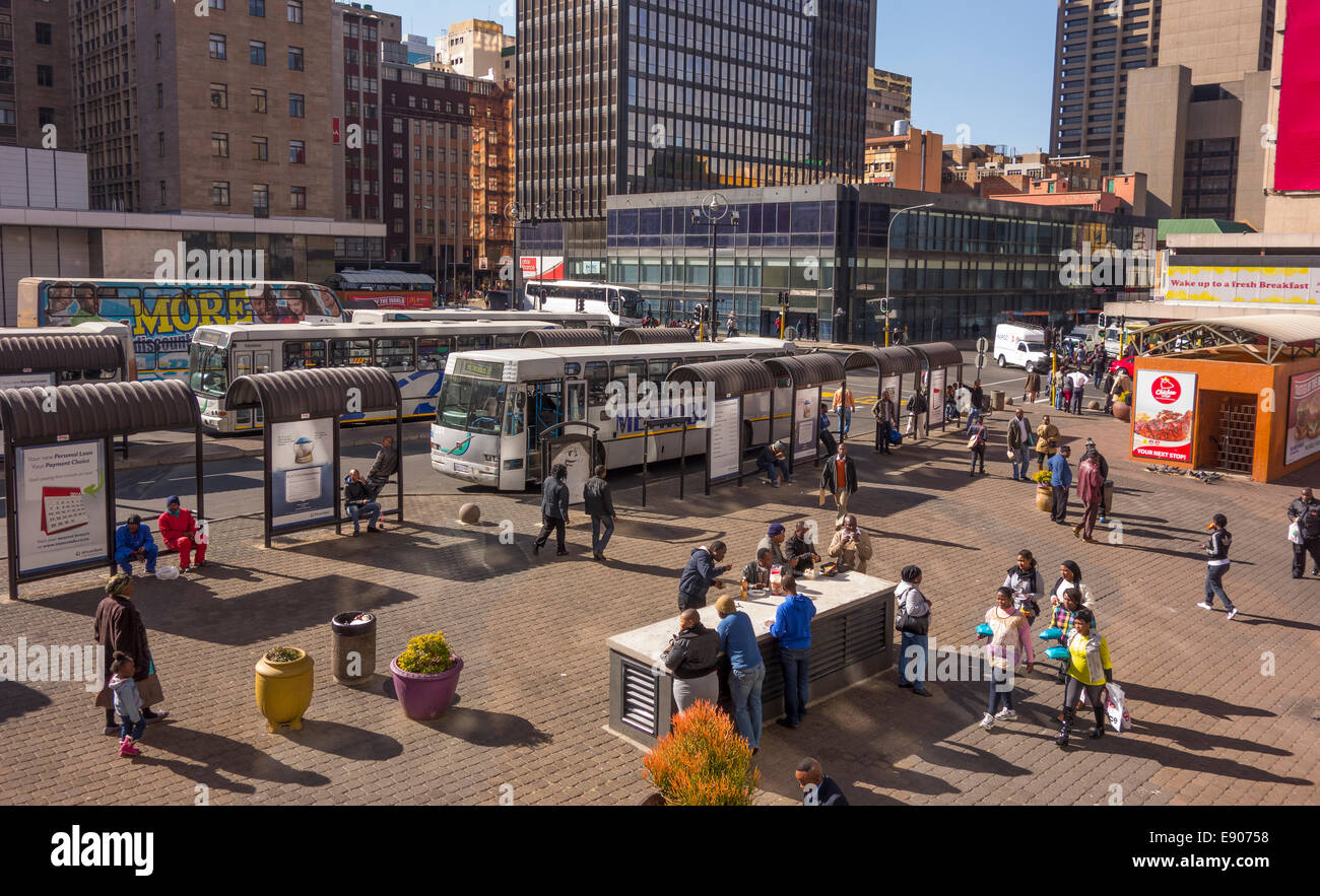 JOHANNESBURG, SOUTH AFRICA - People and buses, in Gandhi Square, in downtown city center. Stock Photo