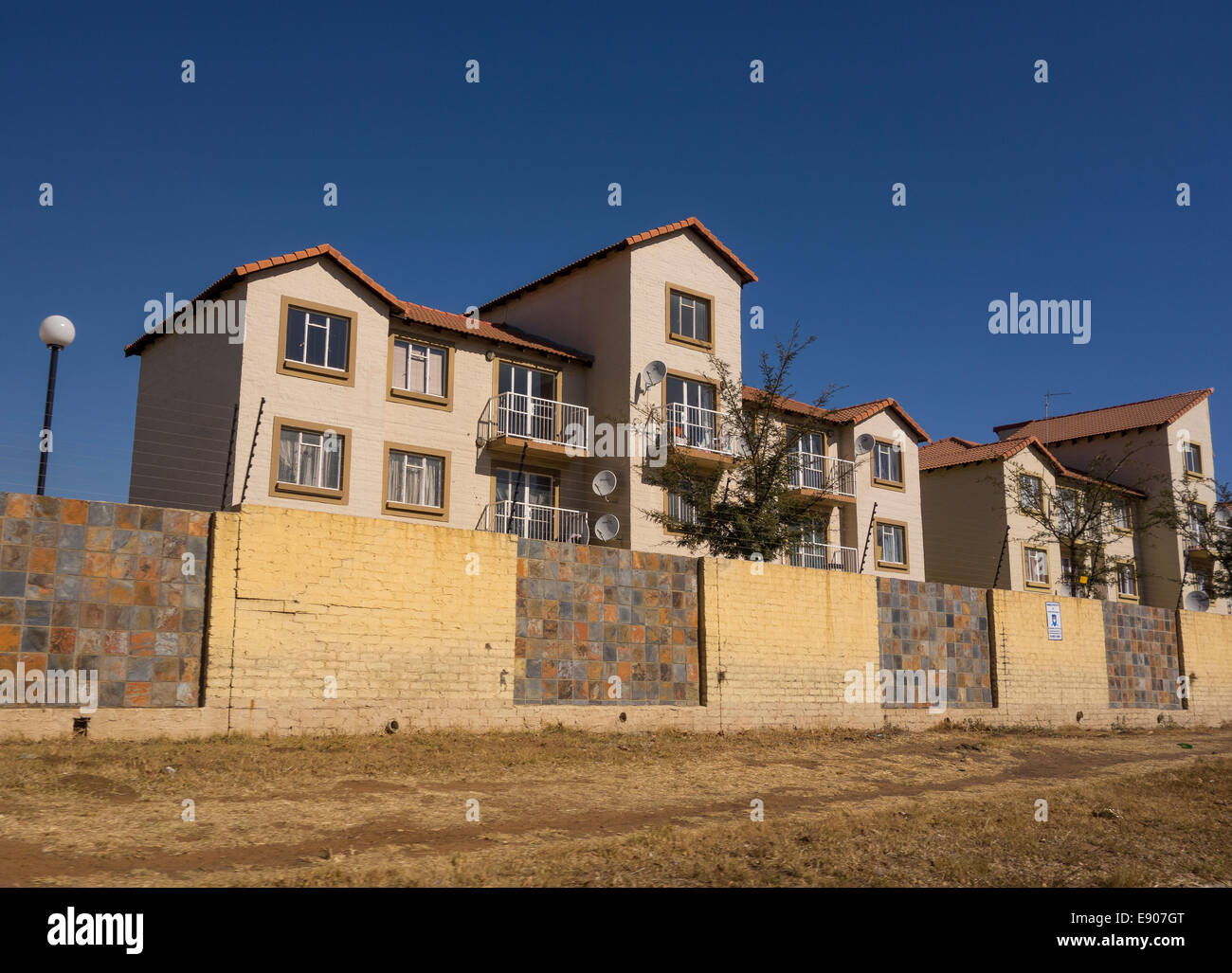 JOHANNESBURG, SOUTH AFRICA - Housing protected behind walls and fencing. Stock Photo