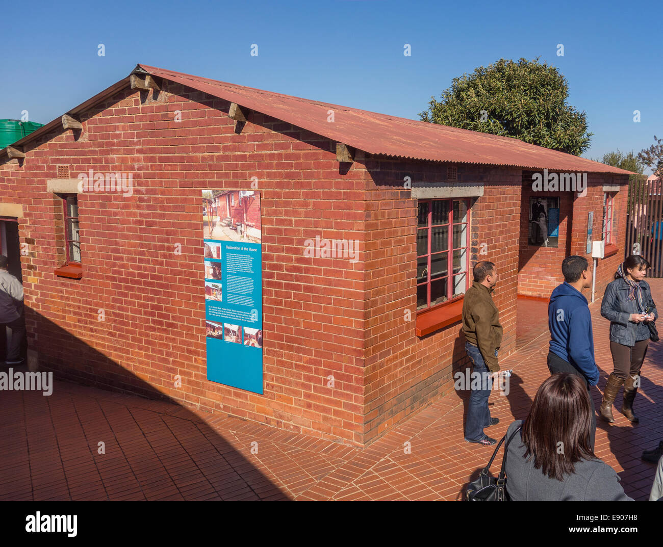 SOWETO, JOHANNESBURG, SOUTH AFRICA - Tour guide with visitors at Soweto home of Nelson Mandela, now a museum. Stock Photo