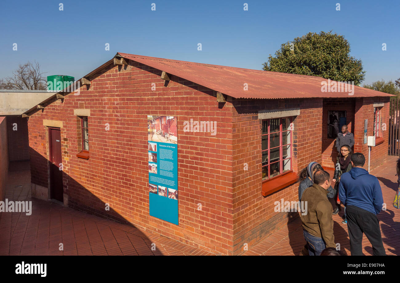 SOWETO, JOHANNESBURG, SOUTH AFRICA - Tour guide with visitors at Soweto home of Nelson Mandela, now a museum. Stock Photo