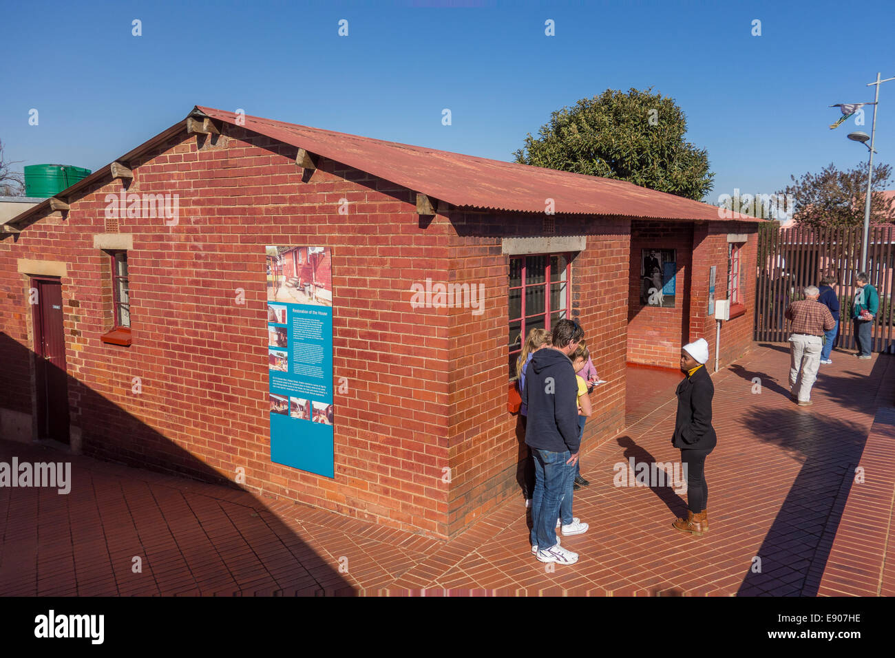 SOWETO, JOHANNESBURG, SOUTH AFRICA - Tour guide with visitors at Soweto home of Nelson Mandela, now a museum. Stock Photo