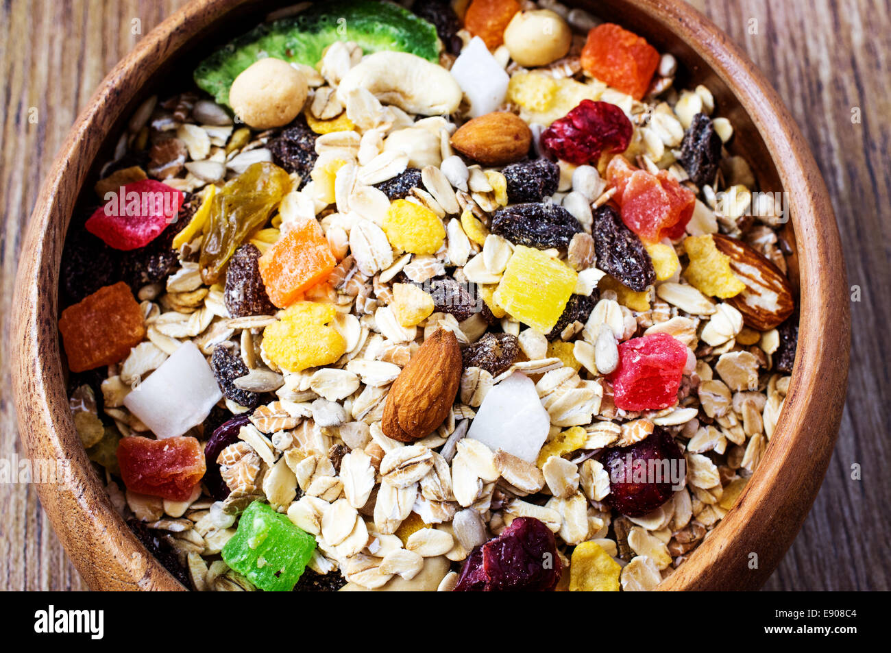 Muesli in bowl with nuts, berries, seeds, candied closeup Stock Photo