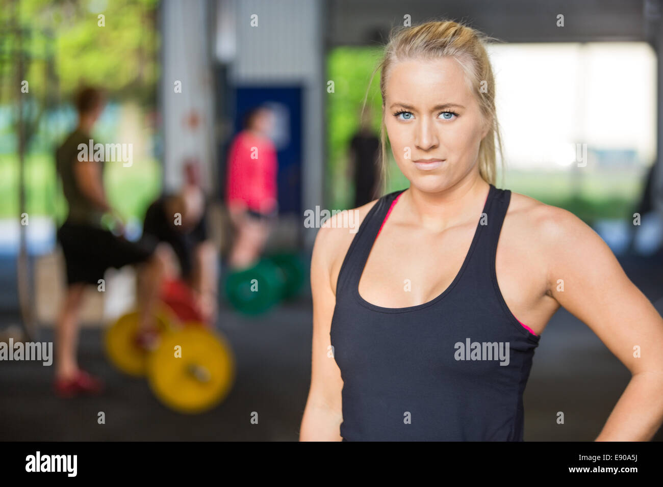 Confident female trainer standing hi-res stock photography and images ...