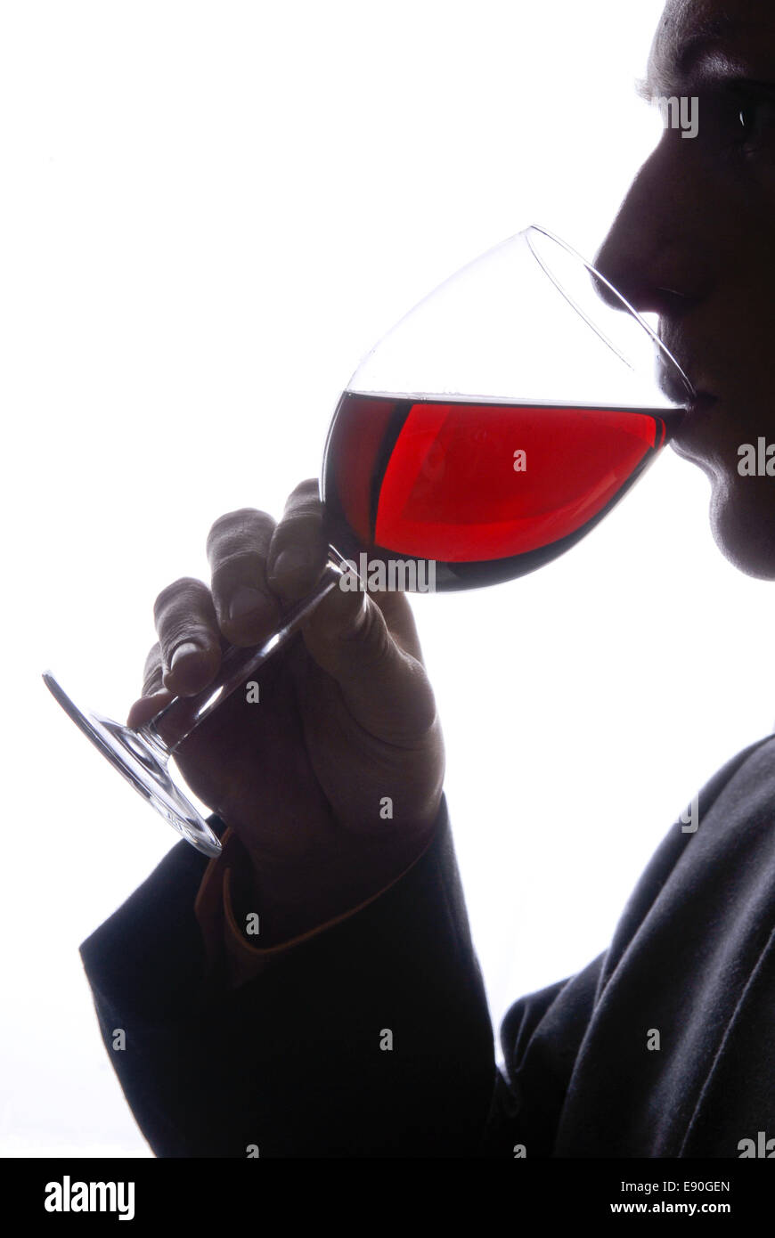 Young man drinking a glass of wine Stock Photo - Alamy