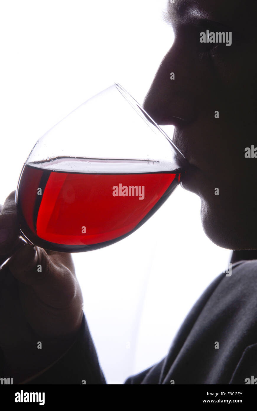 Young man drinking a glass of wine Stock Photo - Alamy