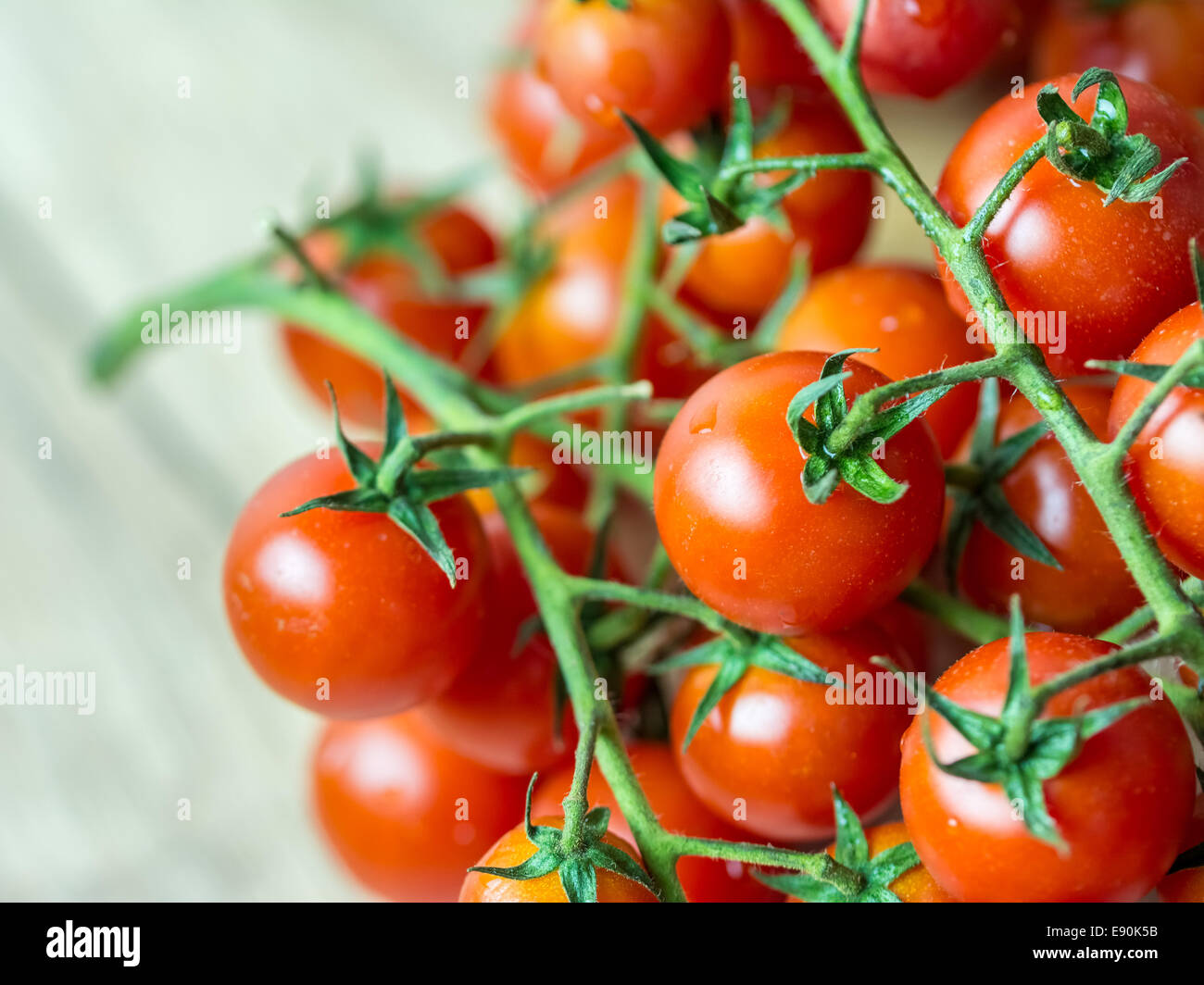 Fresh Cherry Tomatoes On Wood Table Stock Photo - Alamy