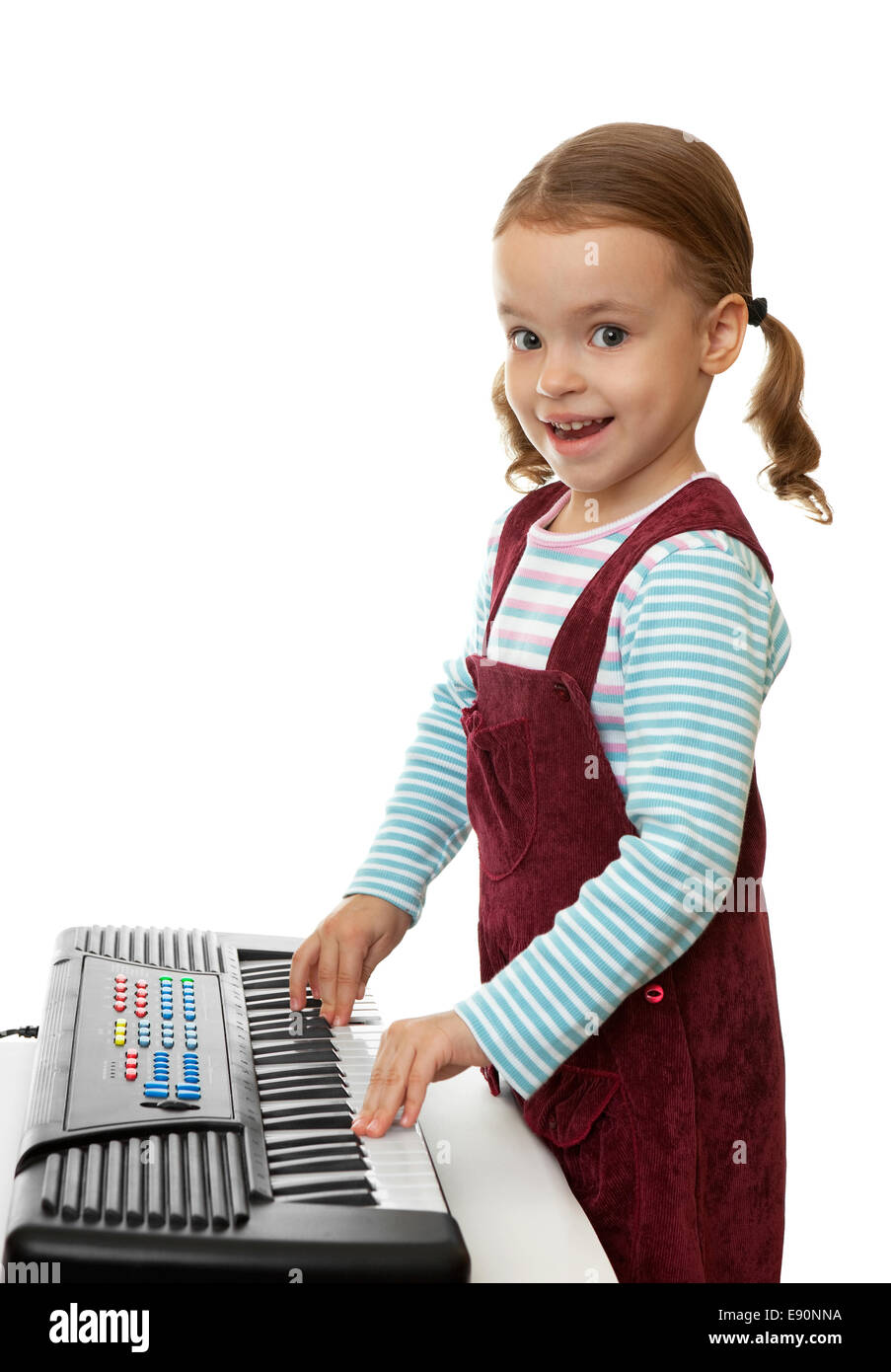 Little girl playing on keyboard instrument Stock Photo Alamy