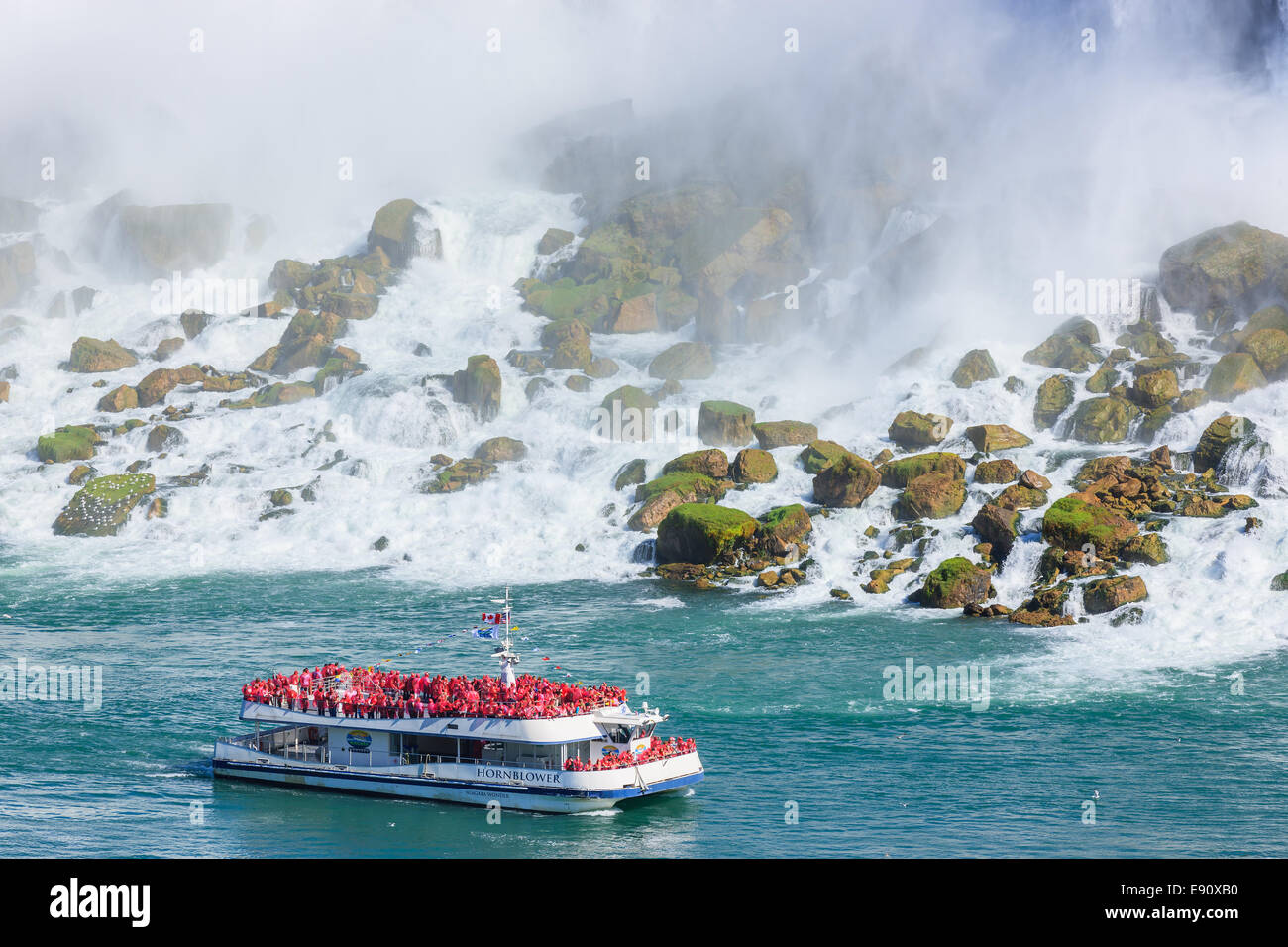 The Hornblower loaded with tourists in front of the American Falls, part of the Niagara Falls, Ontario, Canada. Stock Photo