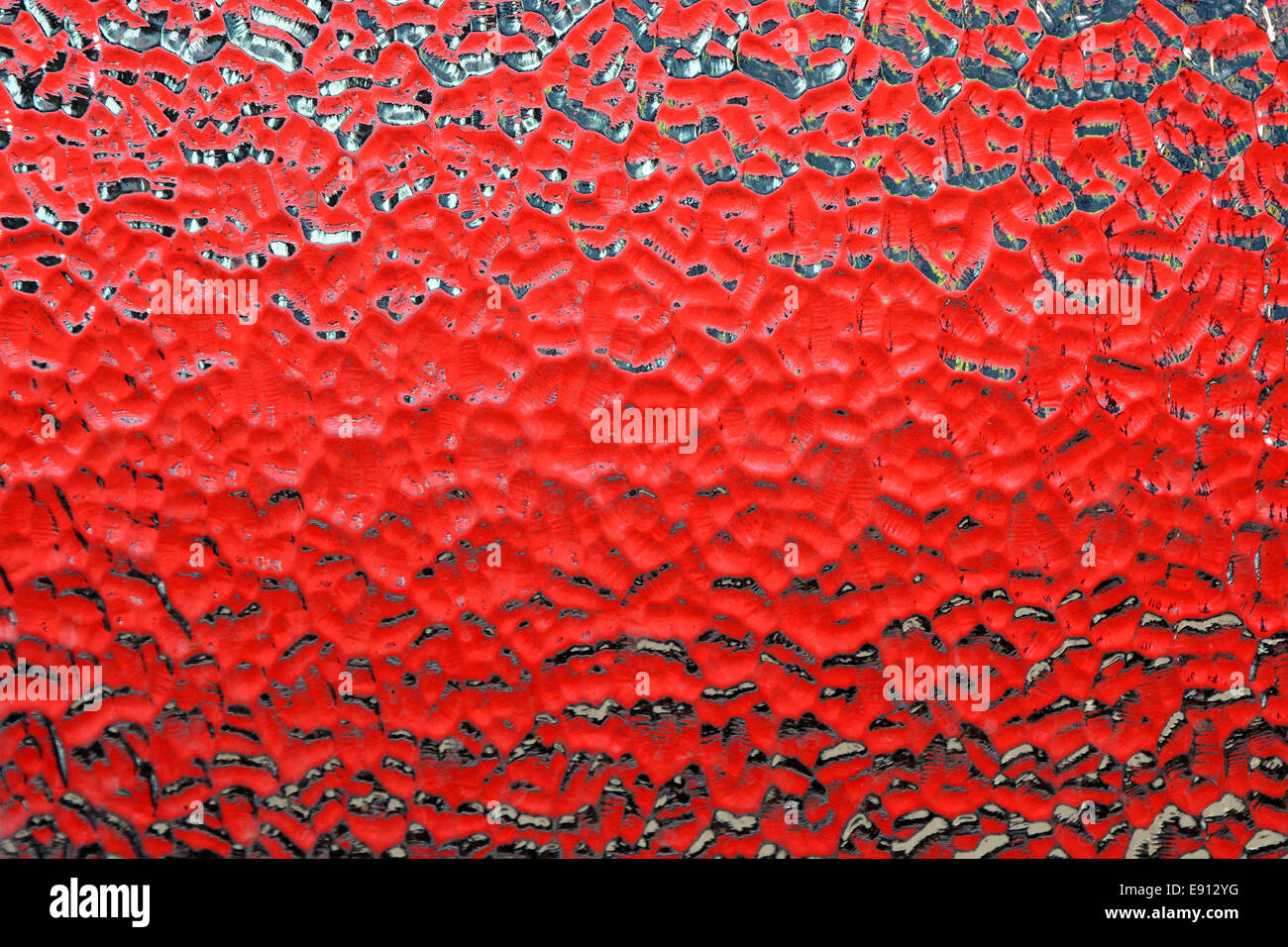 Abstract red pattern formed from vehicle behind moulded glass window ...