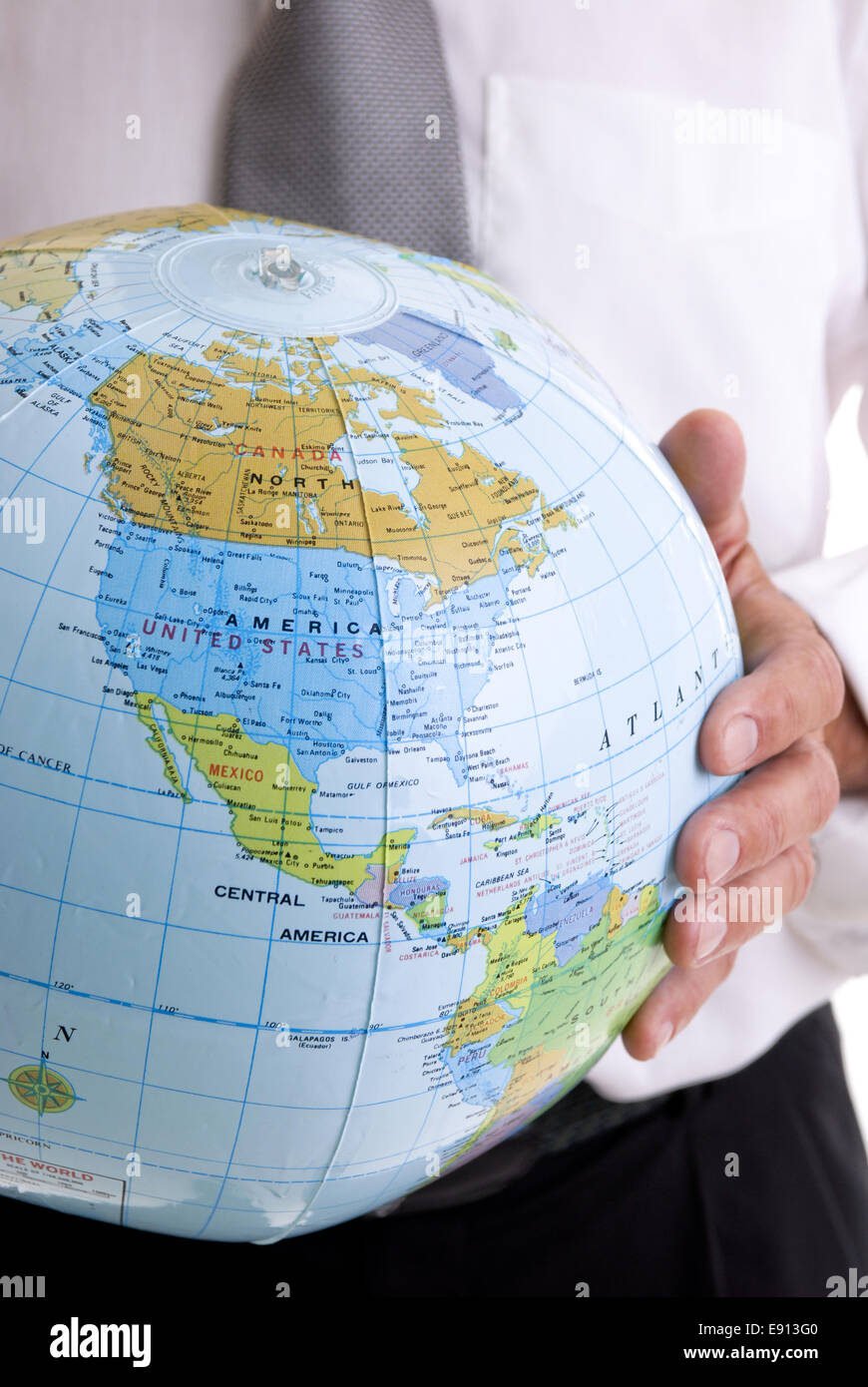 Man holding a globe in his hand Stock Photo