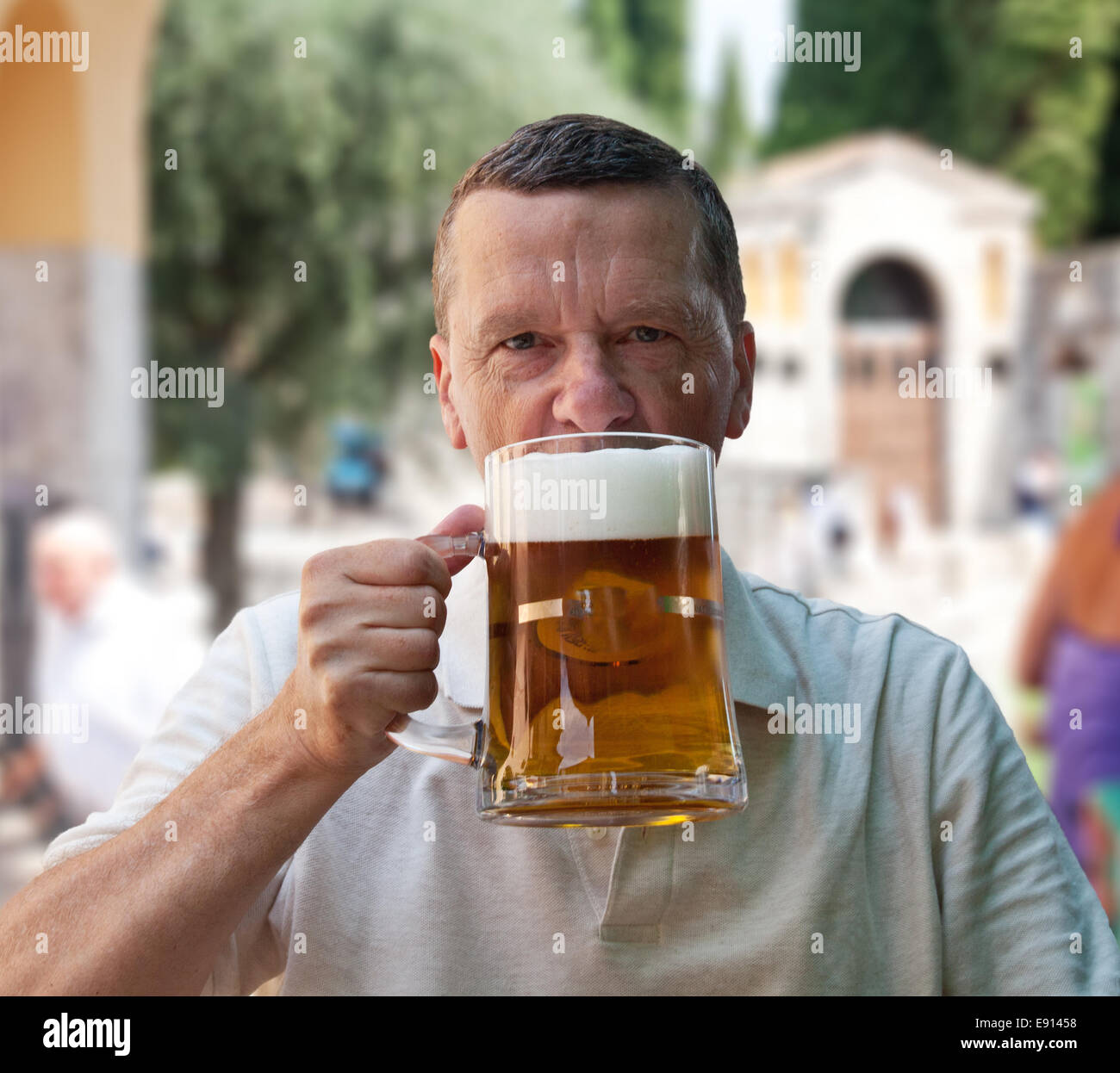 Large liter glass of beer in senior hand Stock Photo