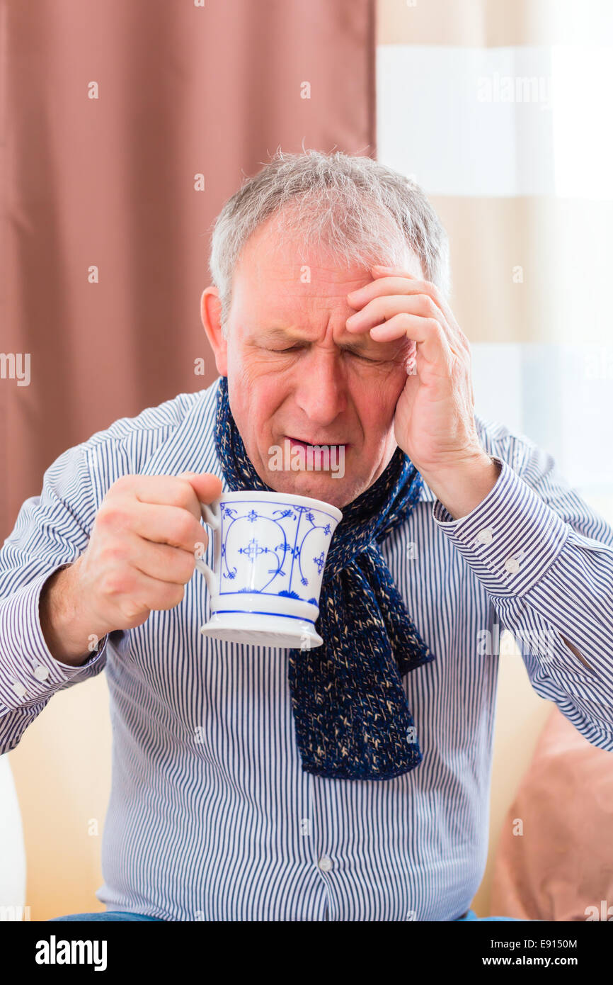Old man drinking tea to cure bad cold or flu at home Stock Photo Alamy