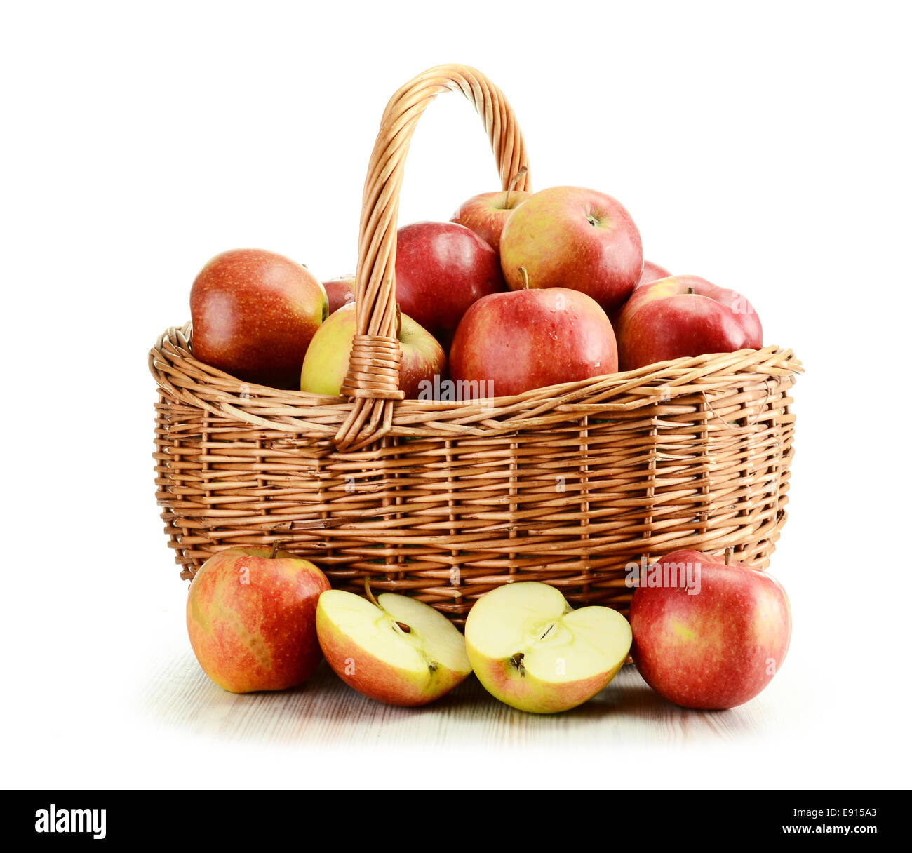 Apples and wicker basket isolated on white Stock Photo - Alamy