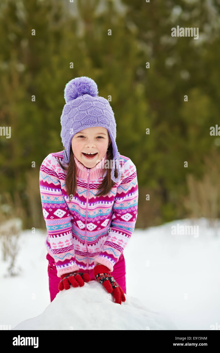 kid playing with snowman Stock Photo