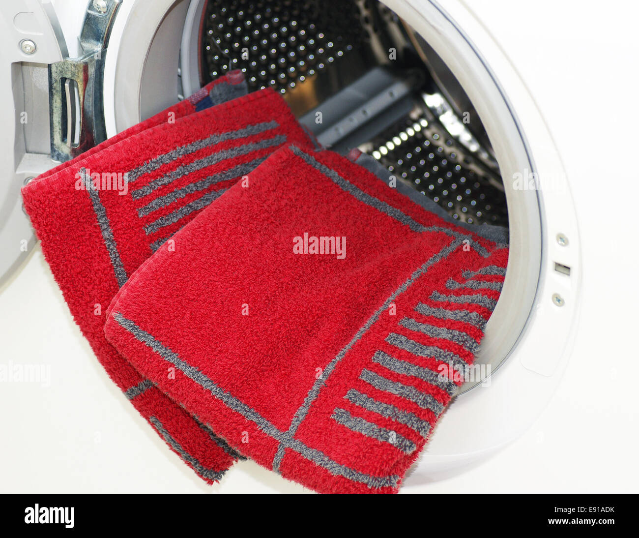 Washing Machine with red Towels Stock Photo