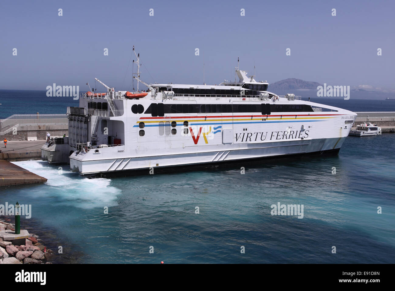 Tarifa Spain a Virtu Ferries ferry boat arrives docks at Tarifa harbour port Stock Photo