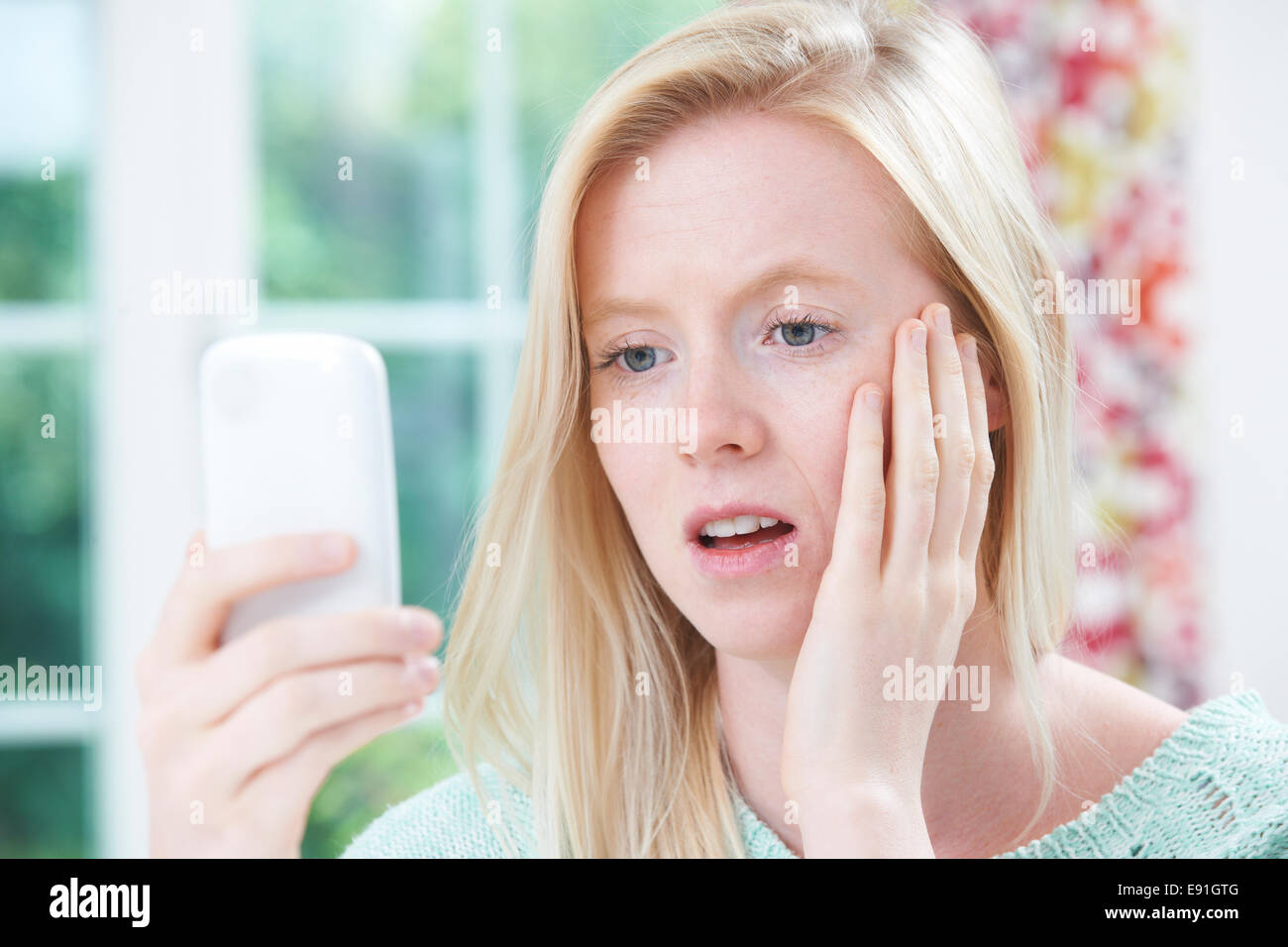 Teenage Girl Victim Of Bullying By Text Message Stock Photo