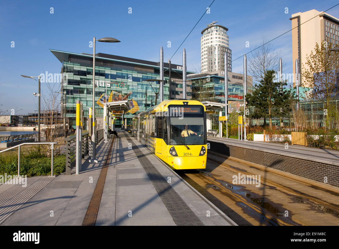 Salford Quays, Greater Manchester, England. Tram departing from the MediaCityUK Metrolink station. Stock Photo
