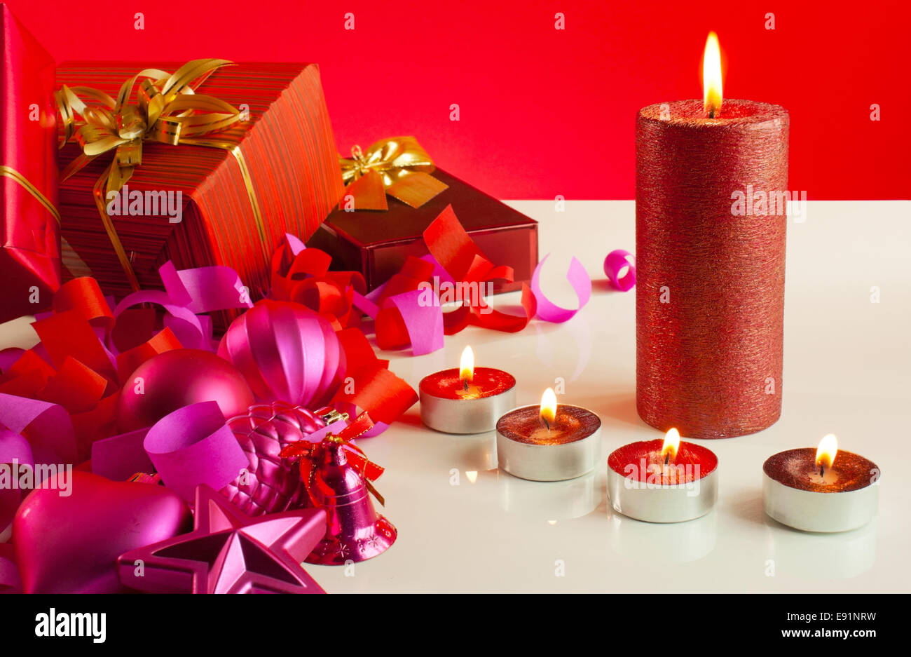 Christmas gifts and four candles Stock Photo Alamy