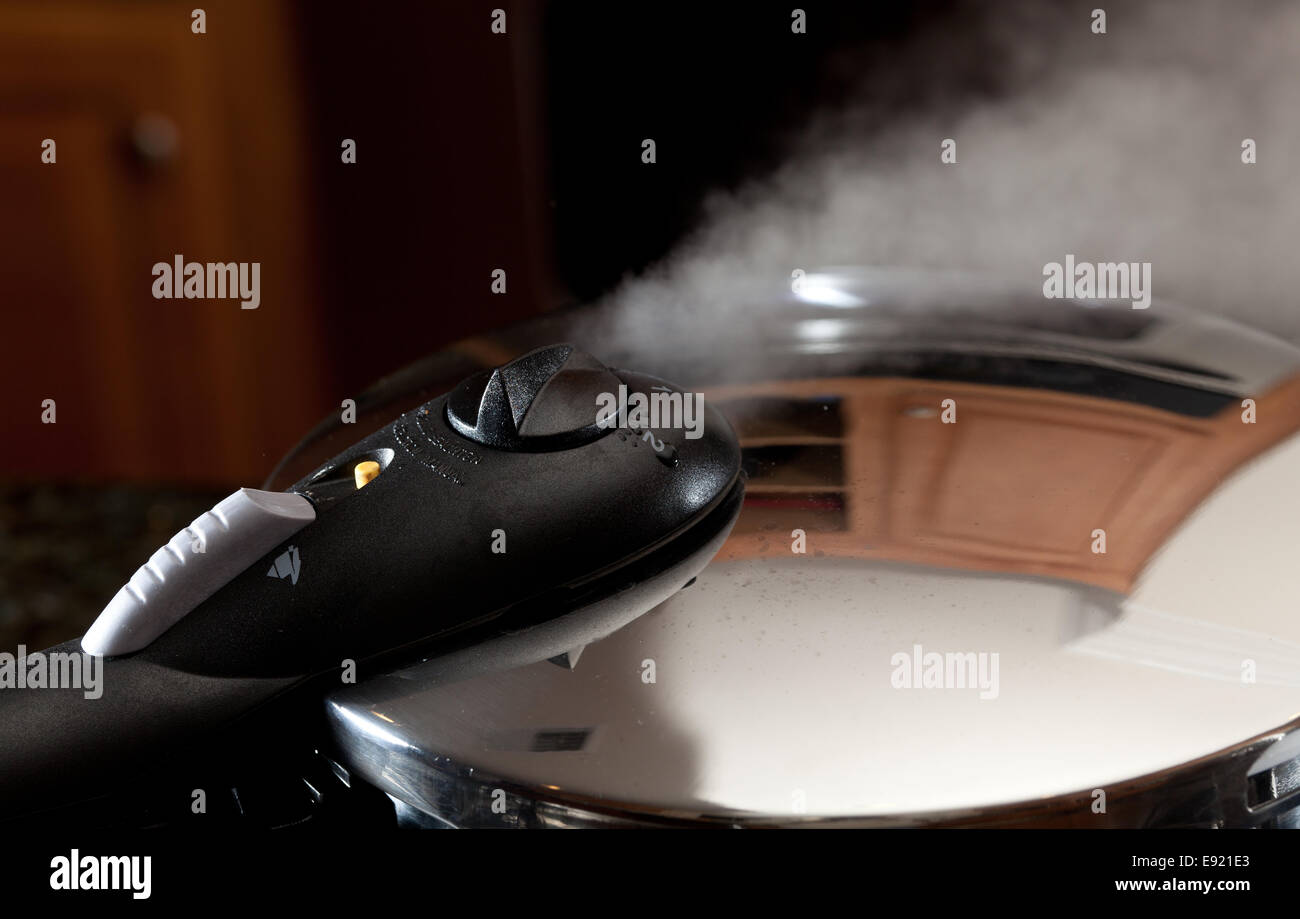 Steam escaping from new pressure cooker pot Stock Photo
