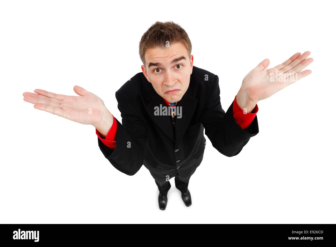 Wide angle top view of a young man showing don't know gesture Stock Photo