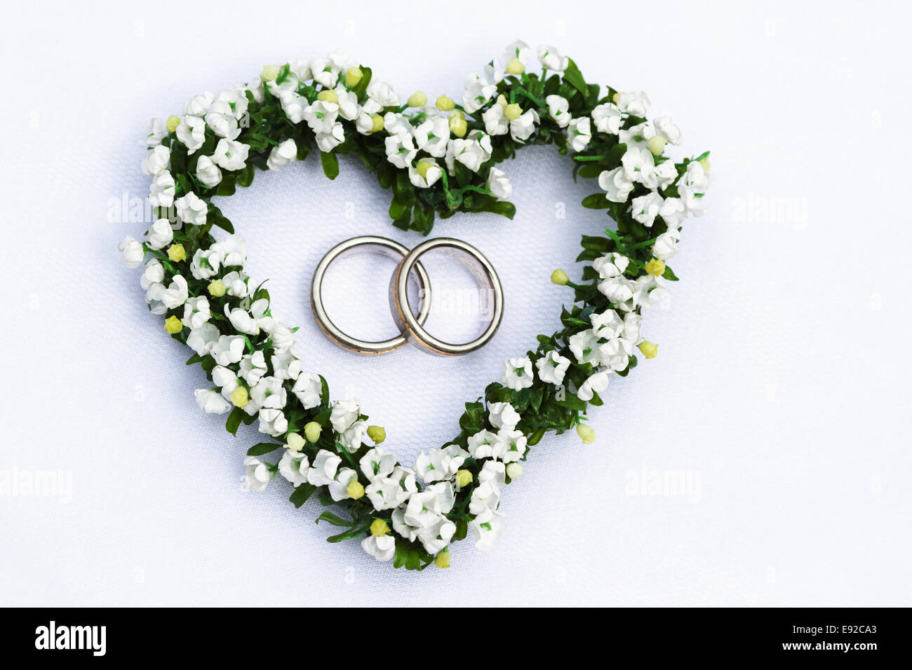 flower heart with wedding rings Stock Photo - Alamy