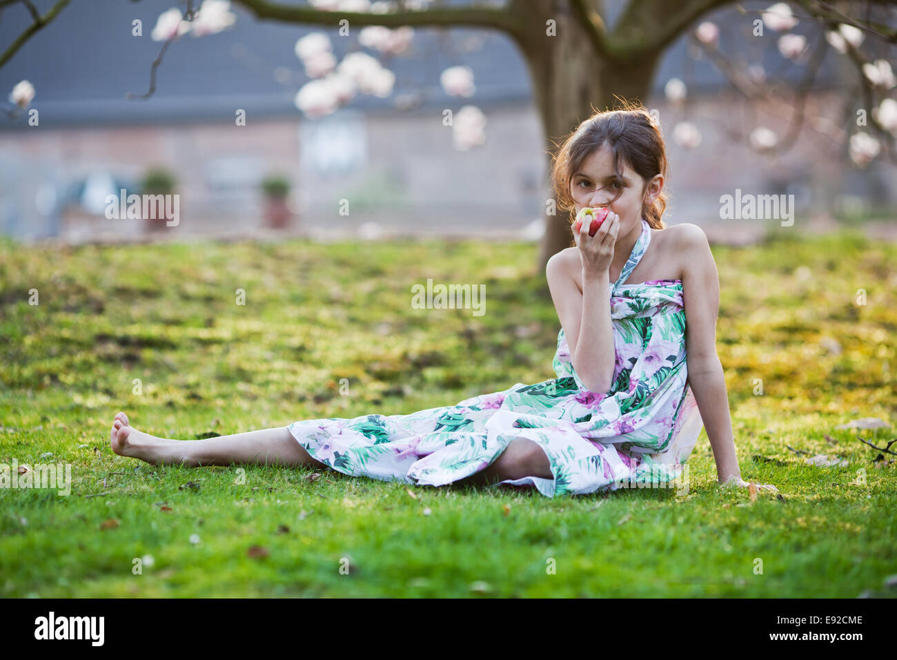 young girl eats an apple Stock Photo