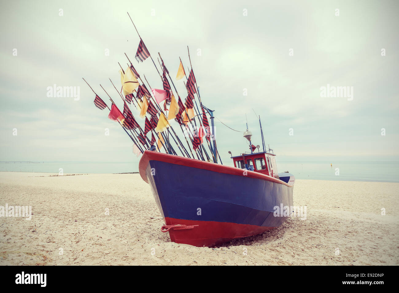 Fishing boat on beach, vintage retro filtered. Stock Photo