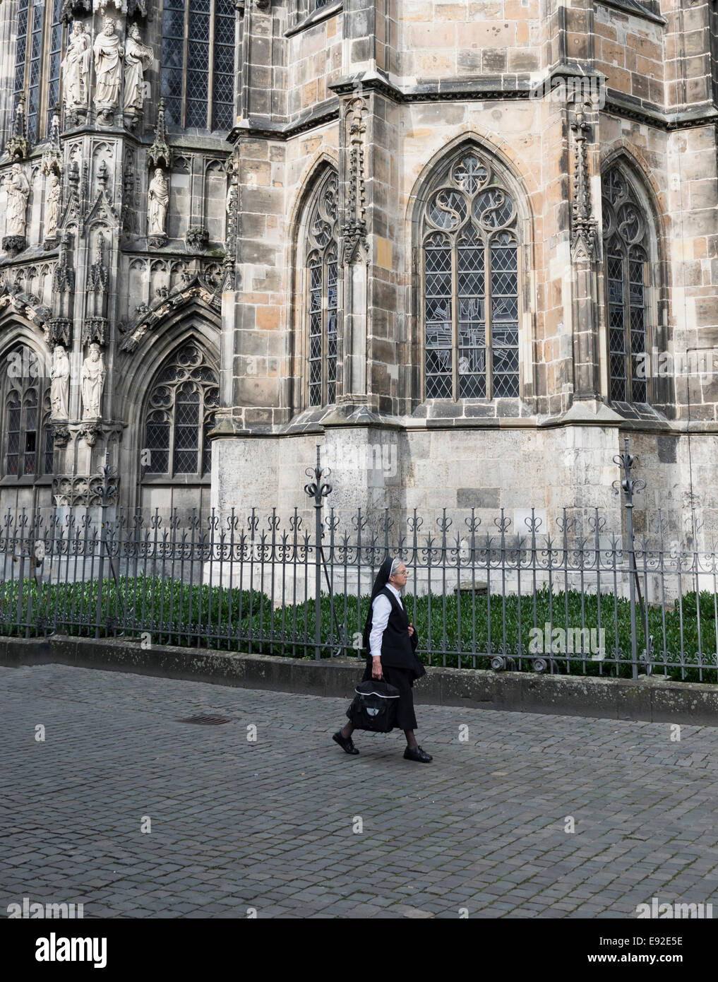 GERMANY,AACHEN - SEPT 29; 2014: Christian non walking on the chaterdal church street of Aachen,Aachen is famous because of the d Stock Photo