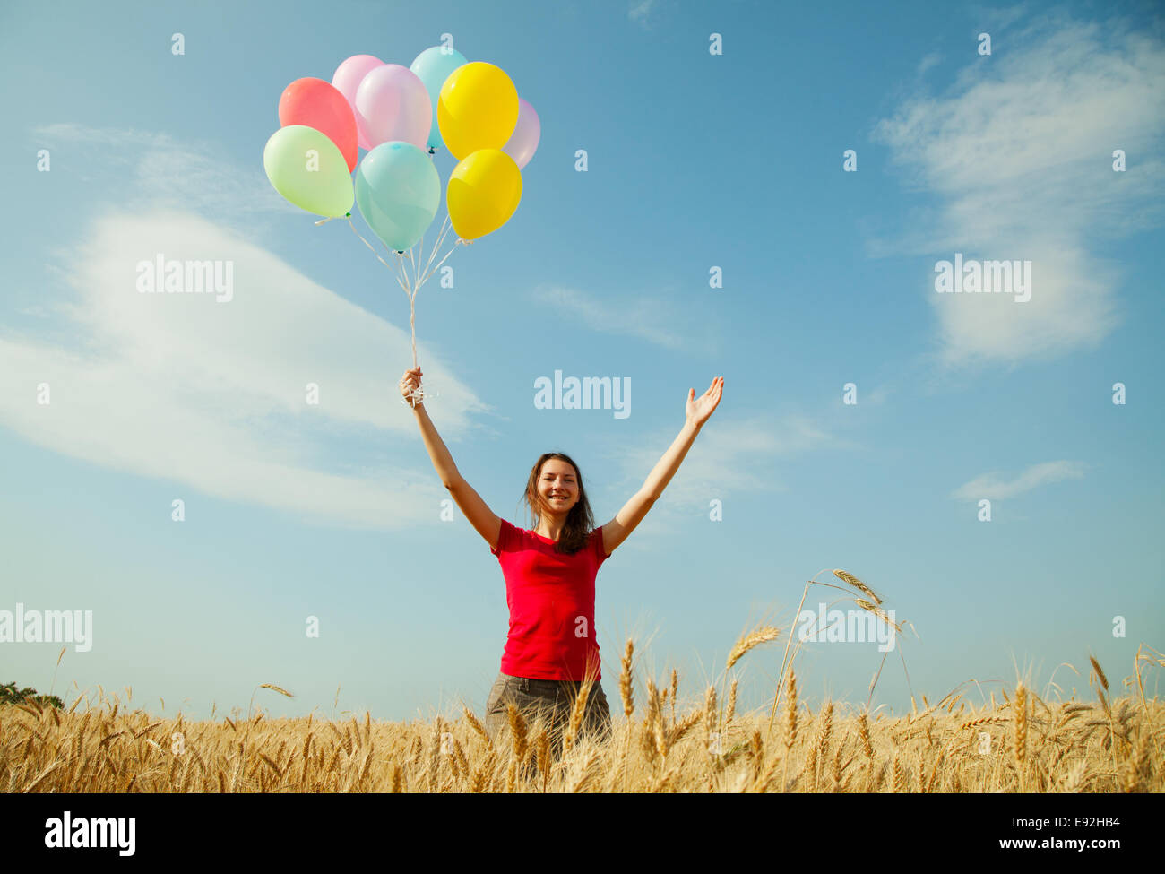 Teen girl at a wheat field with balloons Stock Photo - Alamy