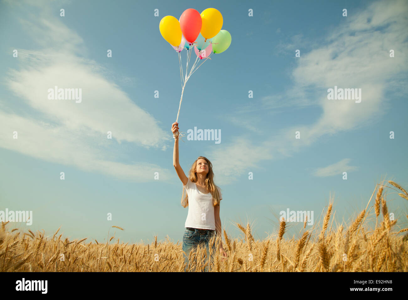 Teen girl at a wheat field with balloons Stock Photo - Alamy