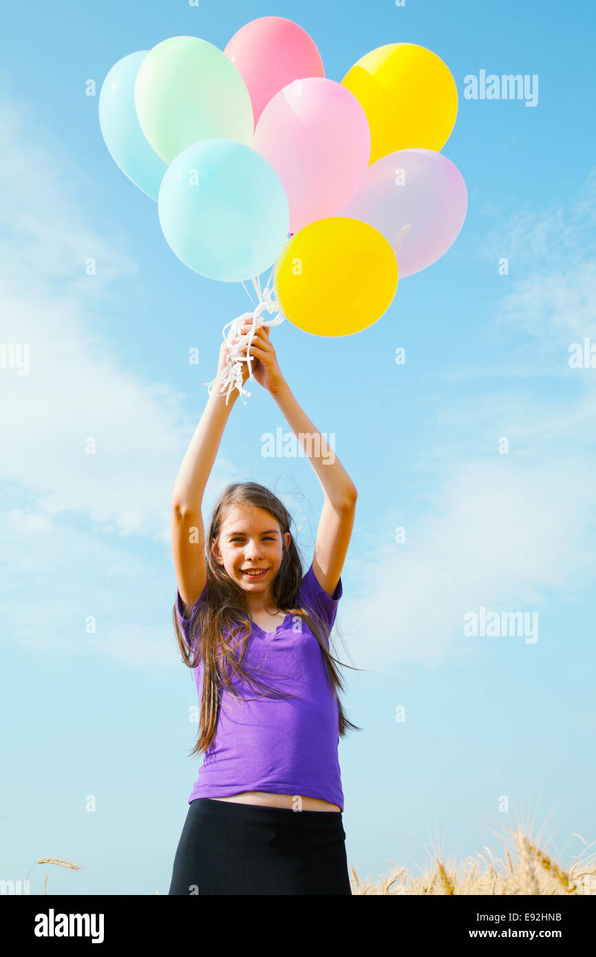 Teen girl at a wheat field with balloons Stock Photo - Alamy
