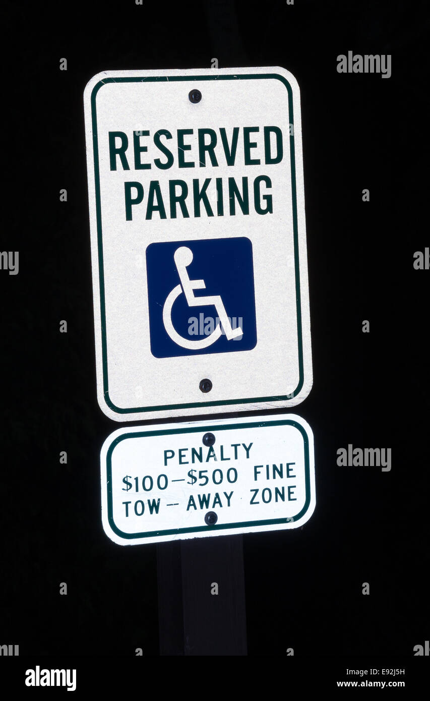Reserved parking sign for disabled at night Stock Photo