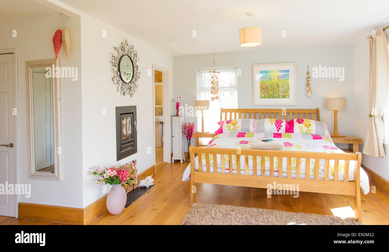 Bright bedroom with fireplace Stock Photo