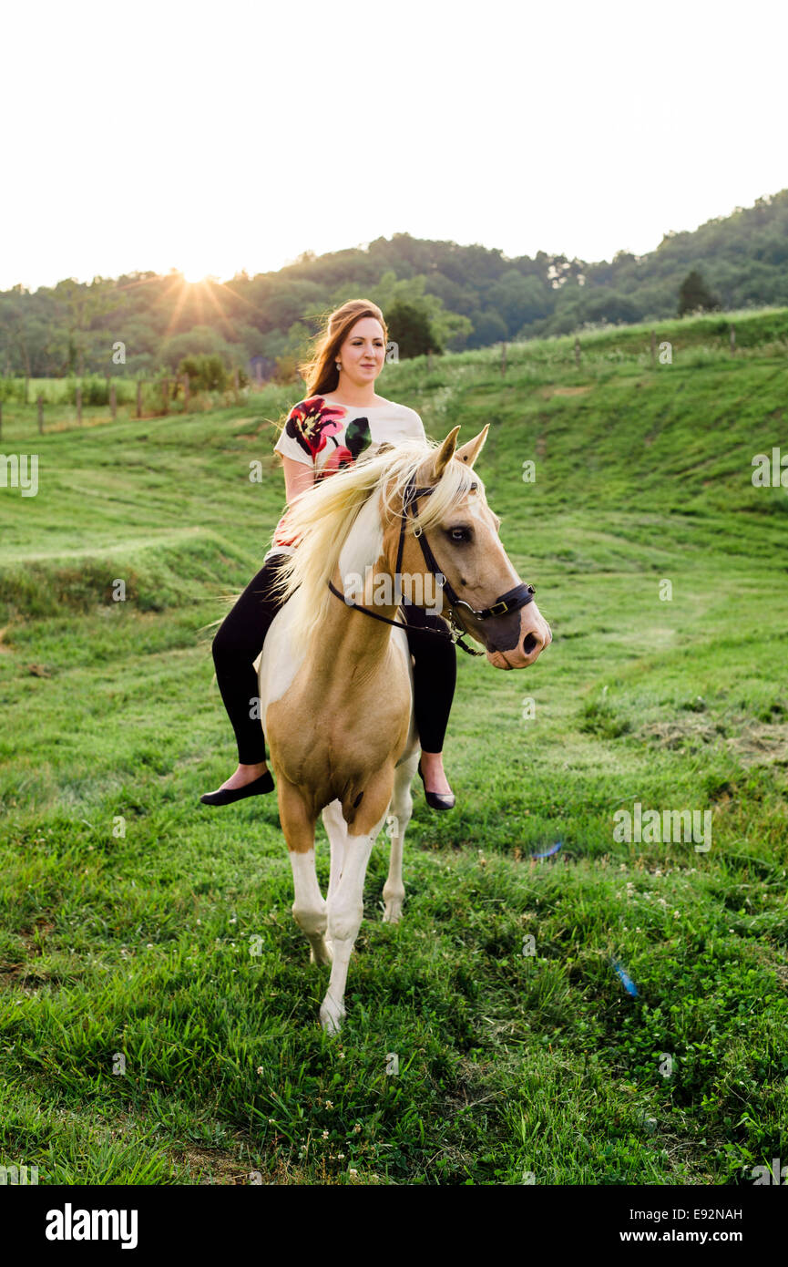 Young Woman Riding Horse Stock Photo