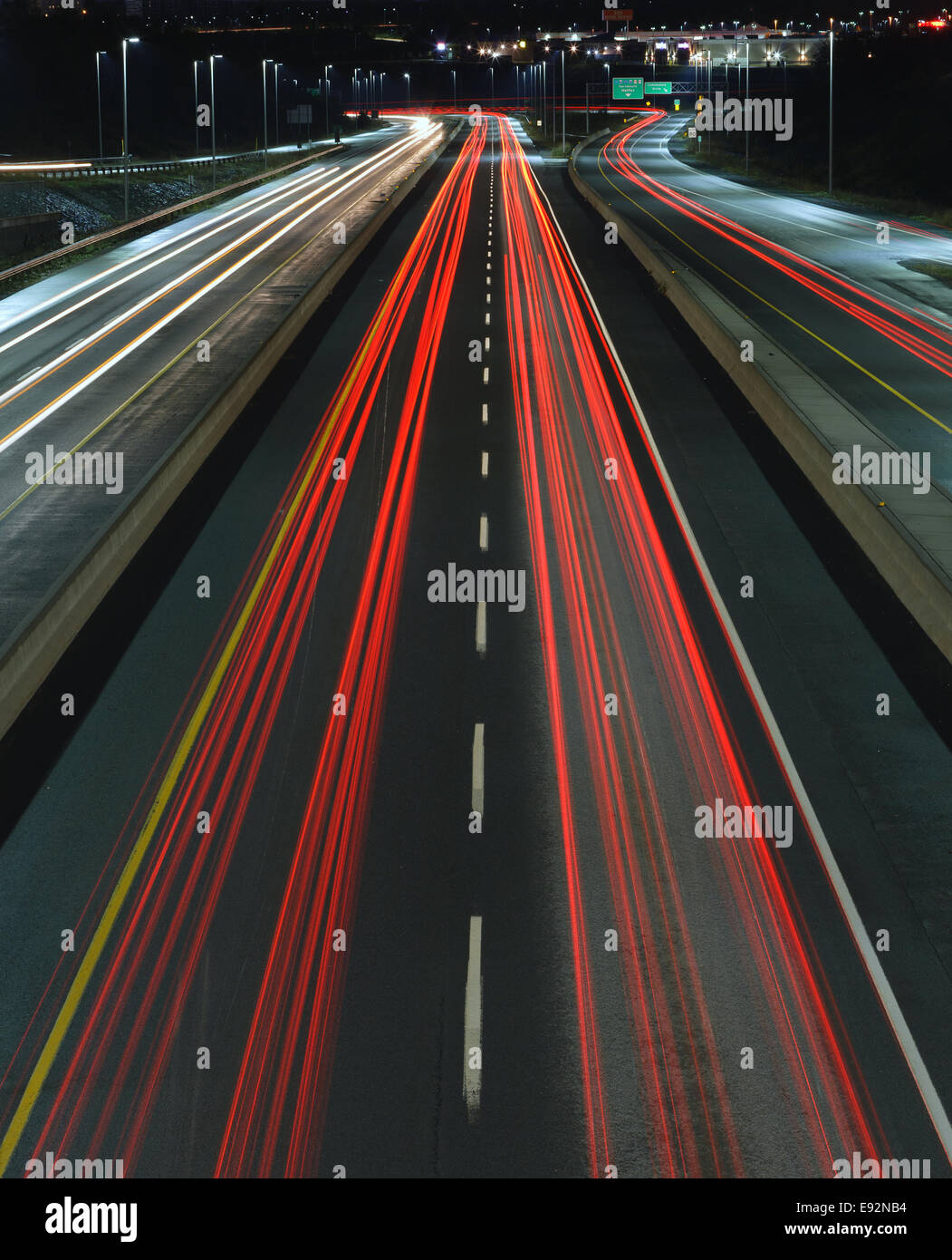 Car trails on a busy highway at night. Stock Photo