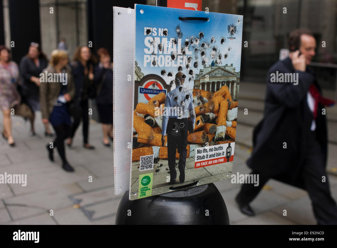 City of London (corporation) anti-butts litter campaign with burn holes from stubbed out cigarattes. Stock Photo