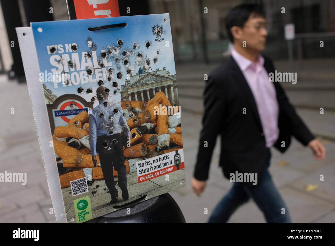 City of London (corporation) anti-butts litter campaign with burn holes from stubbed out cigarattes. Stock Photo