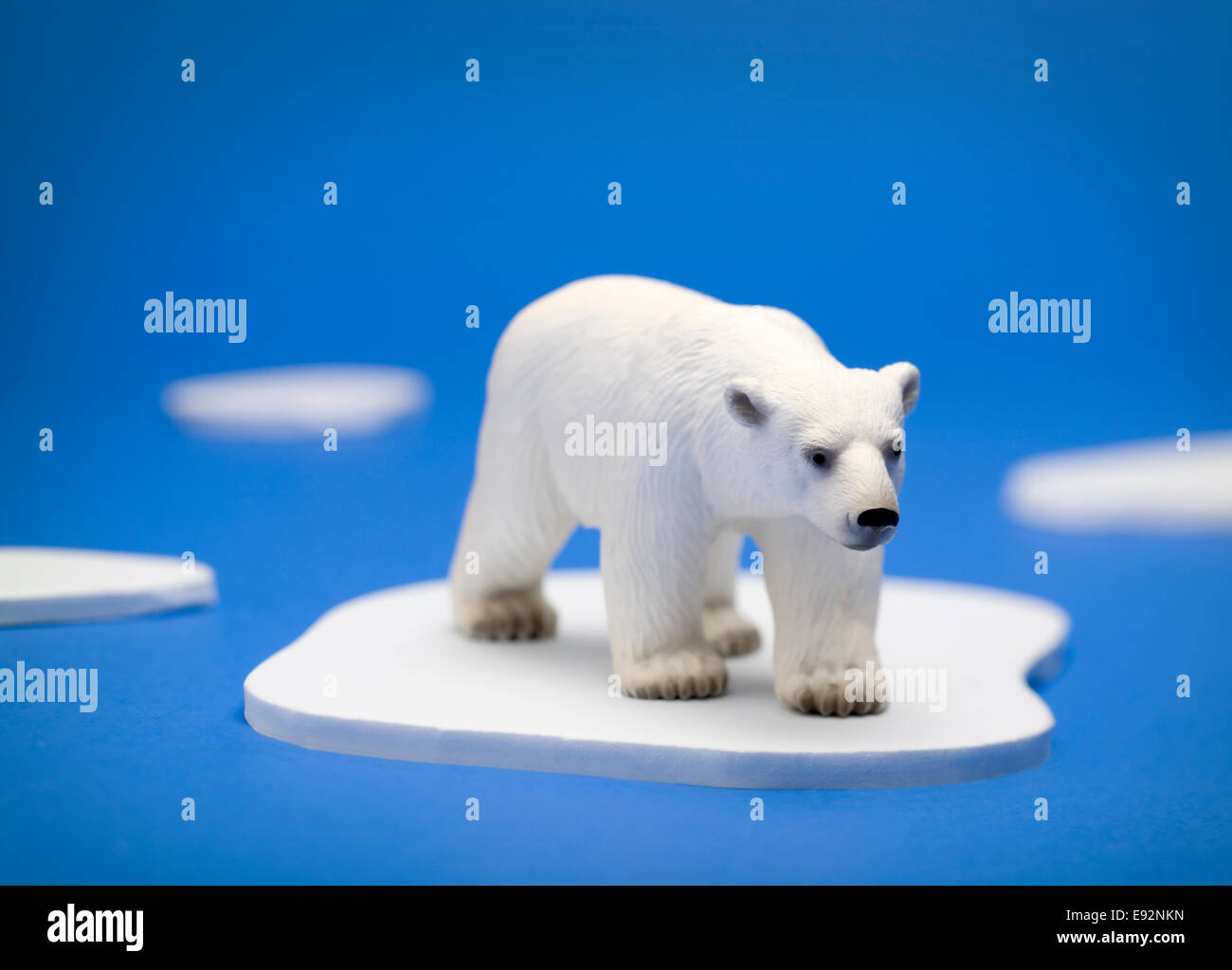 A conceptual illustration showing a polar bear trapped on a melting piece of ice in the Arctic Stock Photo