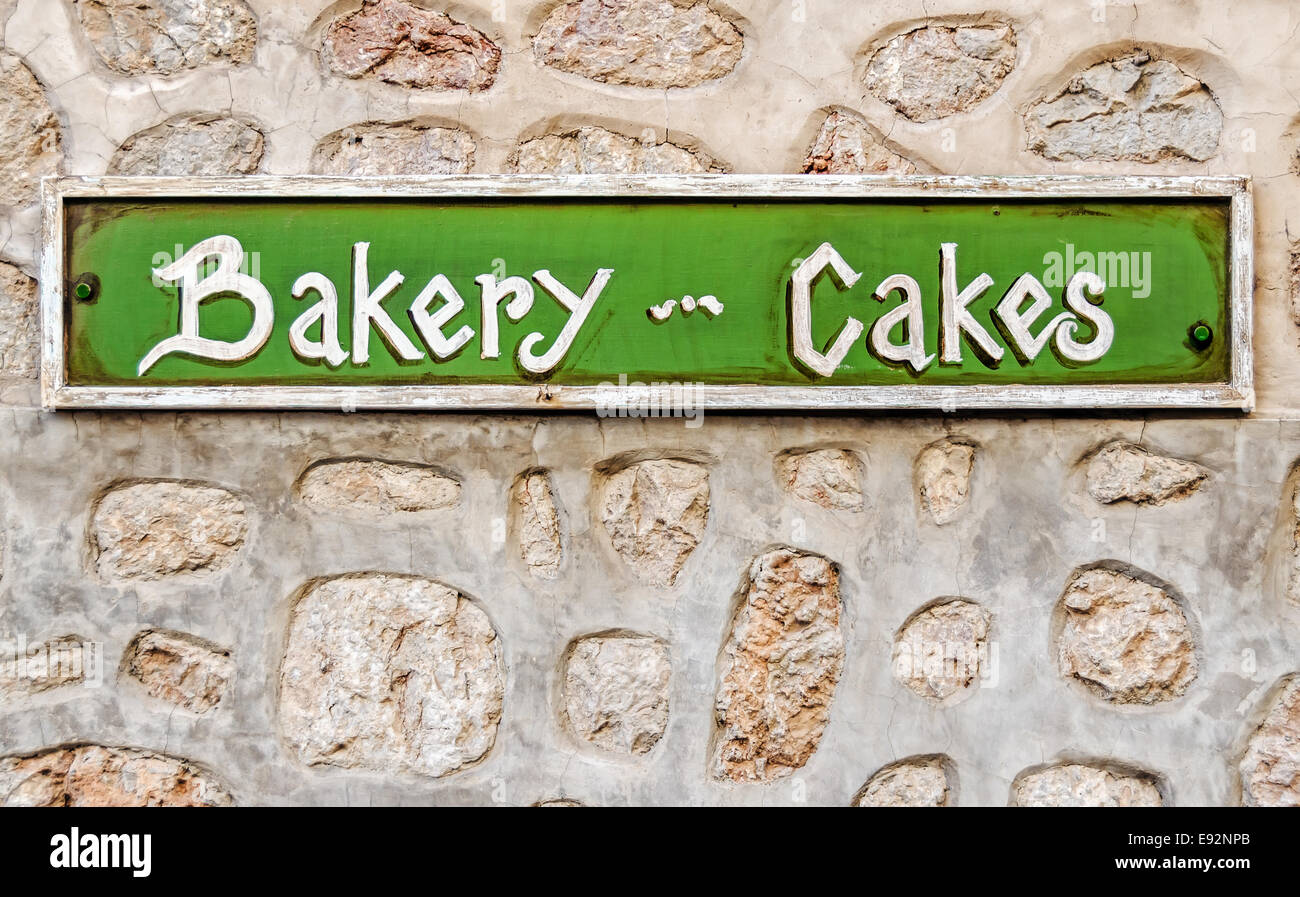 Hand painted bakery cakes sign on a wall Stock Photo - Alamy