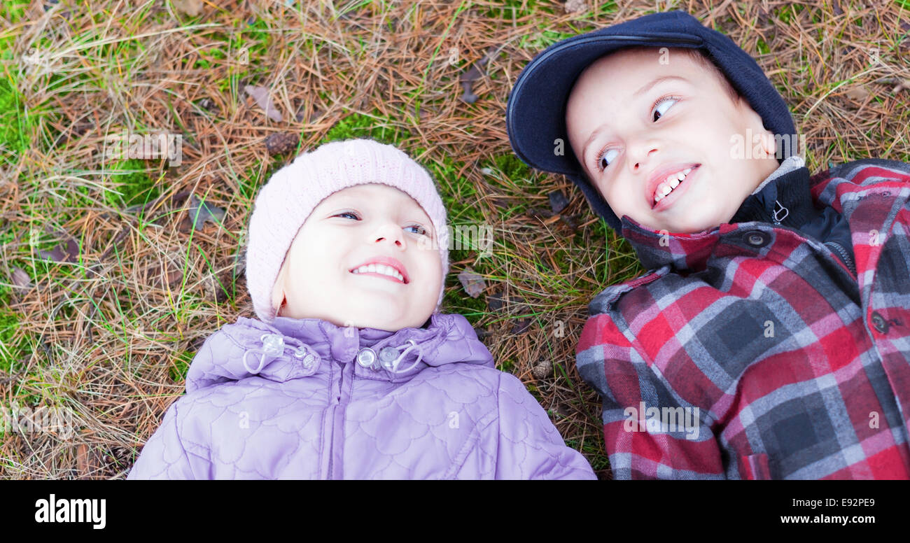 children happy smile brother sister lay ground Stock Photo